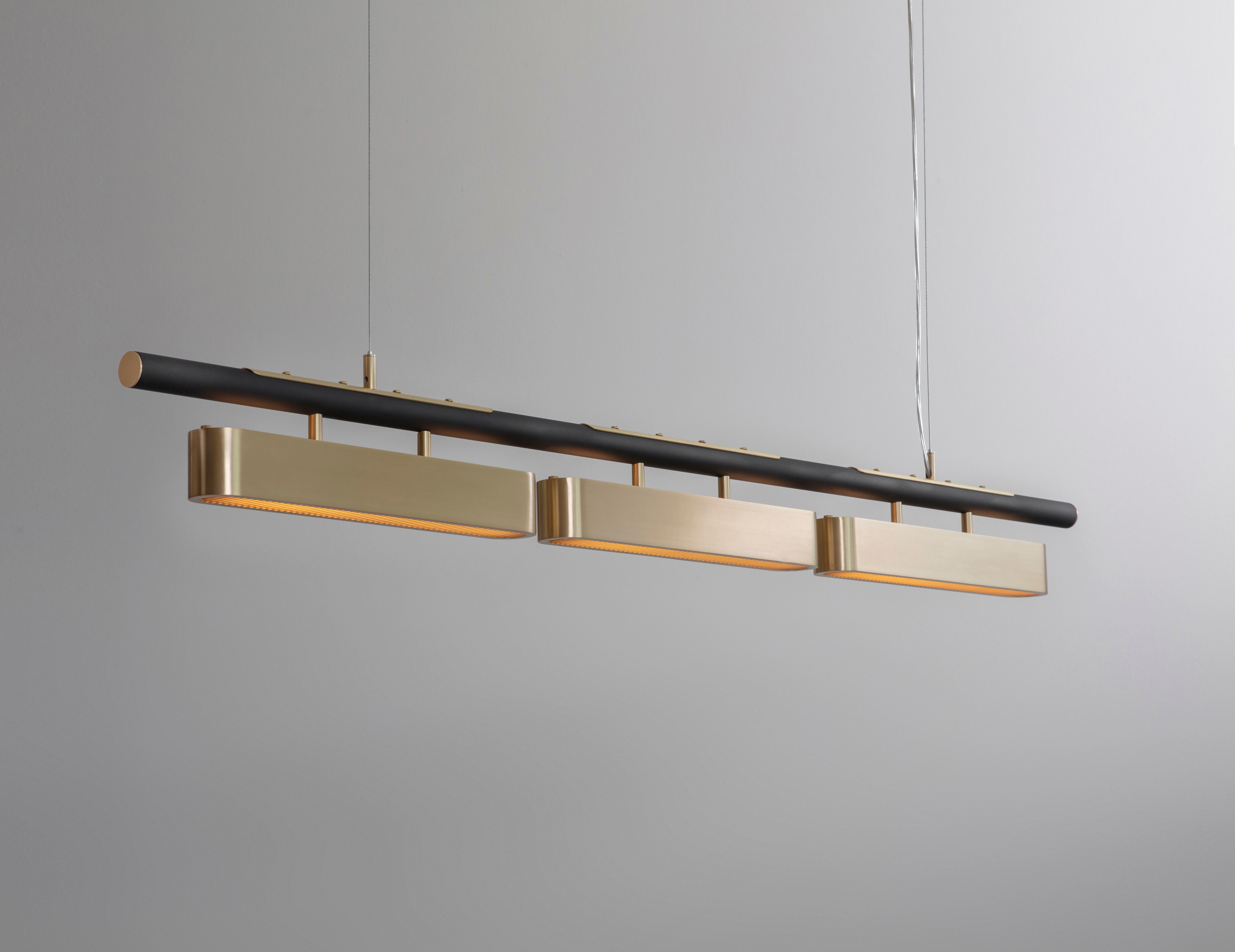 Colt pendant light triple by Bert Frank
Dimensions: 20 x 140 x 12 cm
Materials: Brass, bronze 

Brushed brass lacquered as standard, custom finishes available
All our lamps can be wired according to each country. If sold to the USA it will be