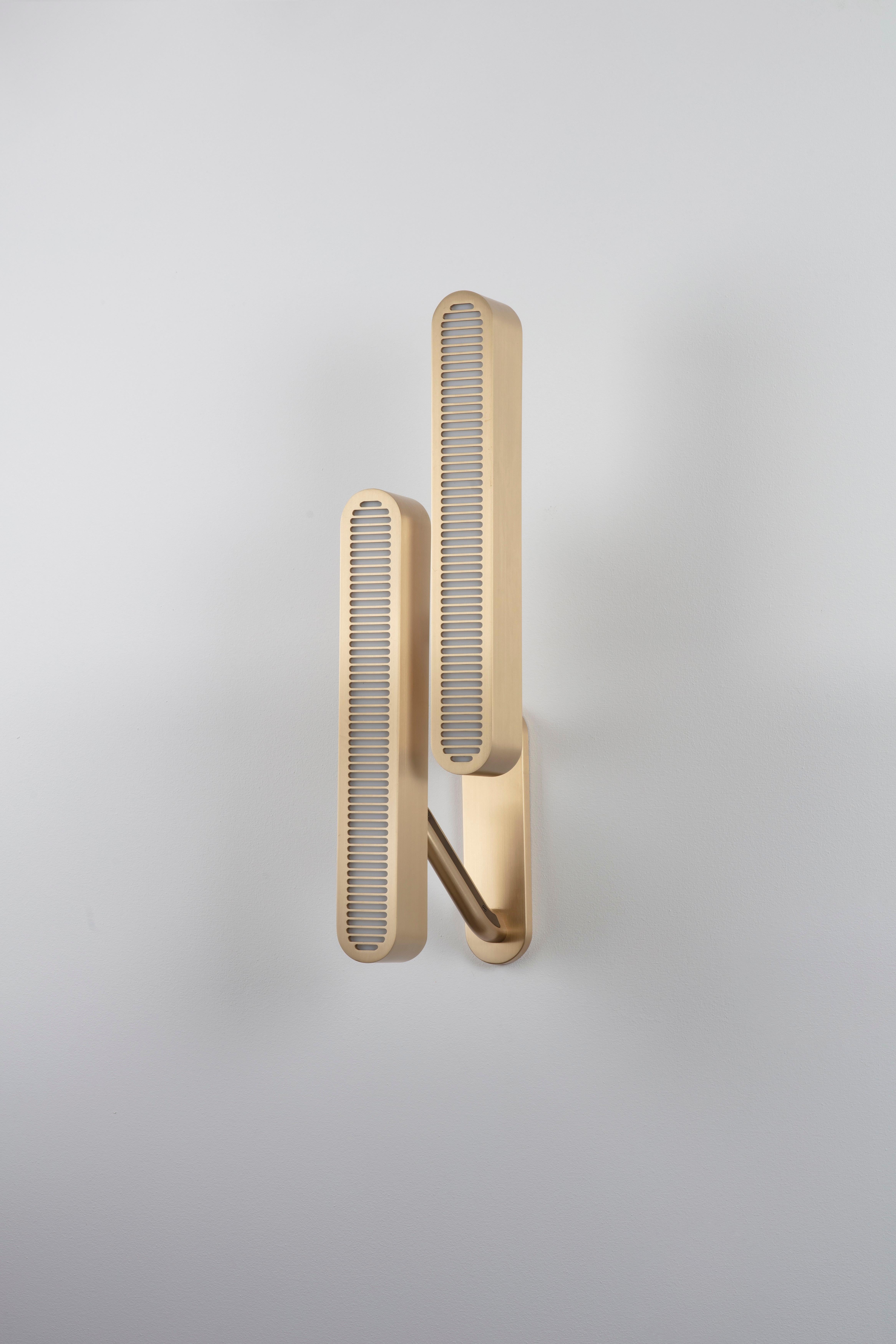 Colt wall light double by Bert Frank
Dimensions: 56.5 x 14.5 x 6 cm
Materials: Brass, bronze

Brushed brass lacquered as standard, custom finishes available.

The Bert Frank aesthetic is one of subtle quirks and twists. Asymmetry is one of