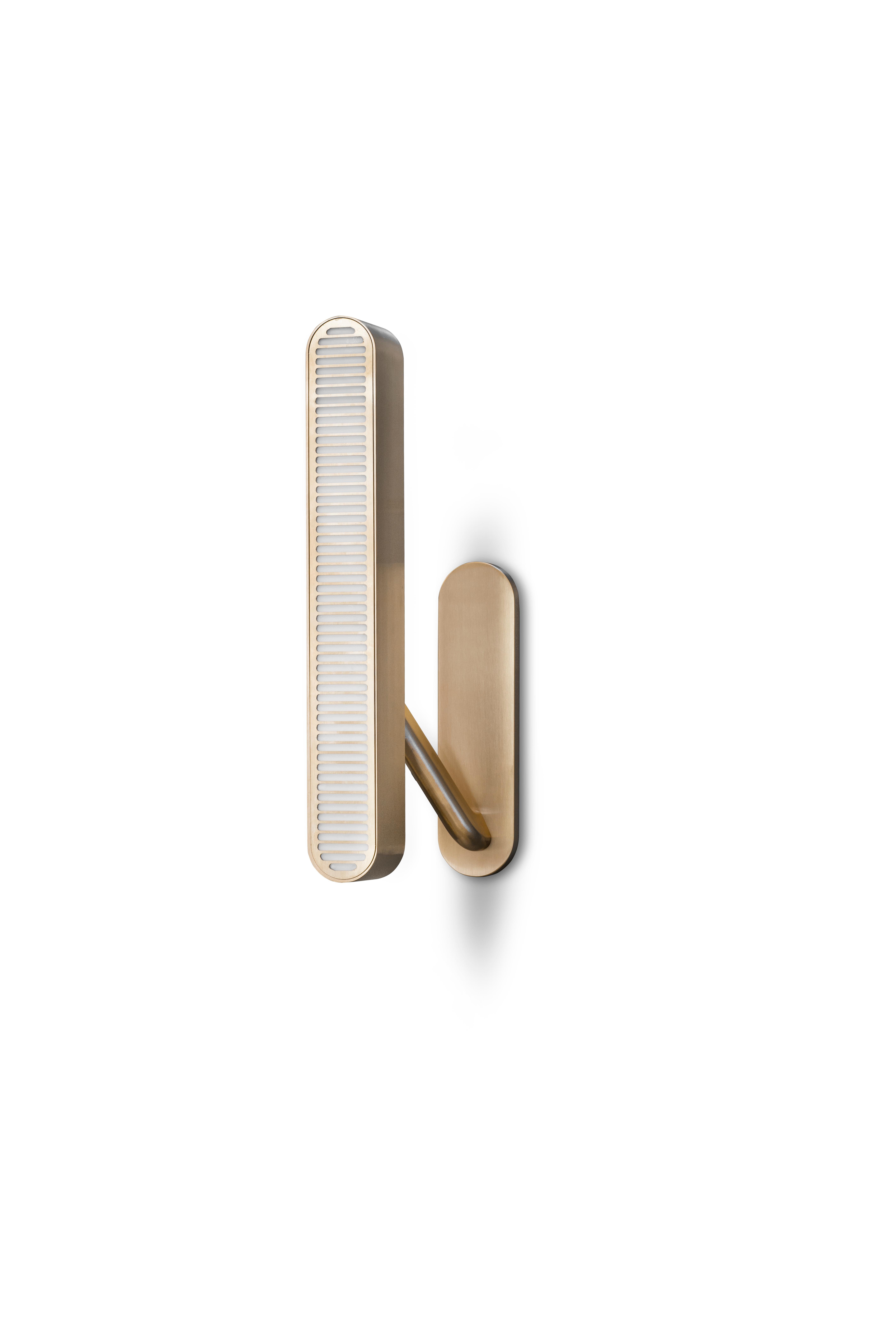 Colt wall light single by Bert Frank
Dimensions: 40 x 10 x 6 cm
Materials: Brass, bronze

Brushed brass lacquered as standard, custom finishes available.

The Bert Frank aesthetic is one of subtle quirks and twists. Asymmetry is one of those. Colt