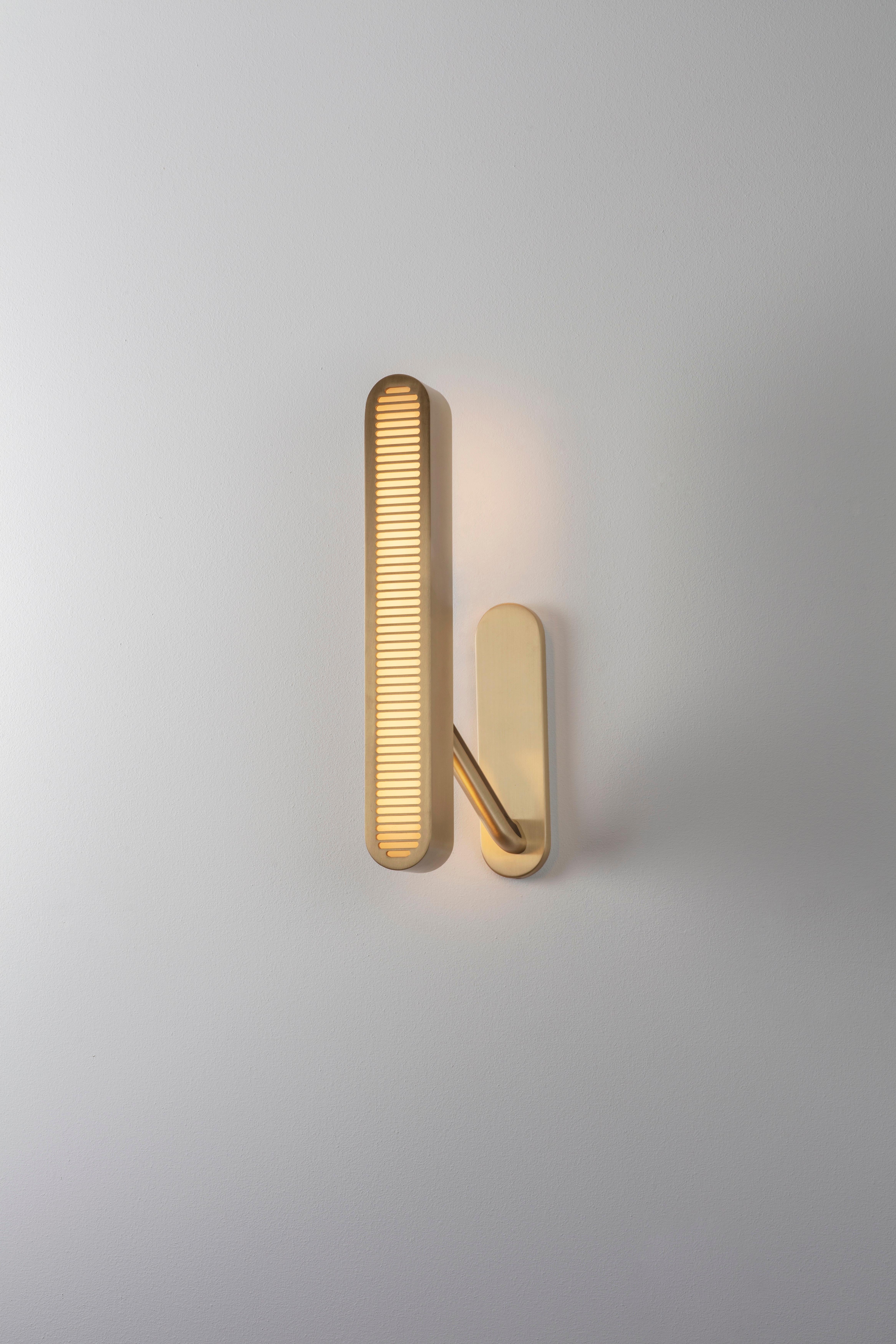 Colt wall light single by Bert Frank
Dimensions: 17 x 10 x 40 cm
Materials: Brass, bronze

Brushed brass lacquered as standard, custom finishes available.

The Bert Frank aesthetic is one of subtle quirks and twists. Asymmetry is one of those. Colt