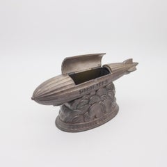 COLUMBIA 1931 Antico Dirigibile Zeppelin Film Figurale Porta sigarette da tavolo