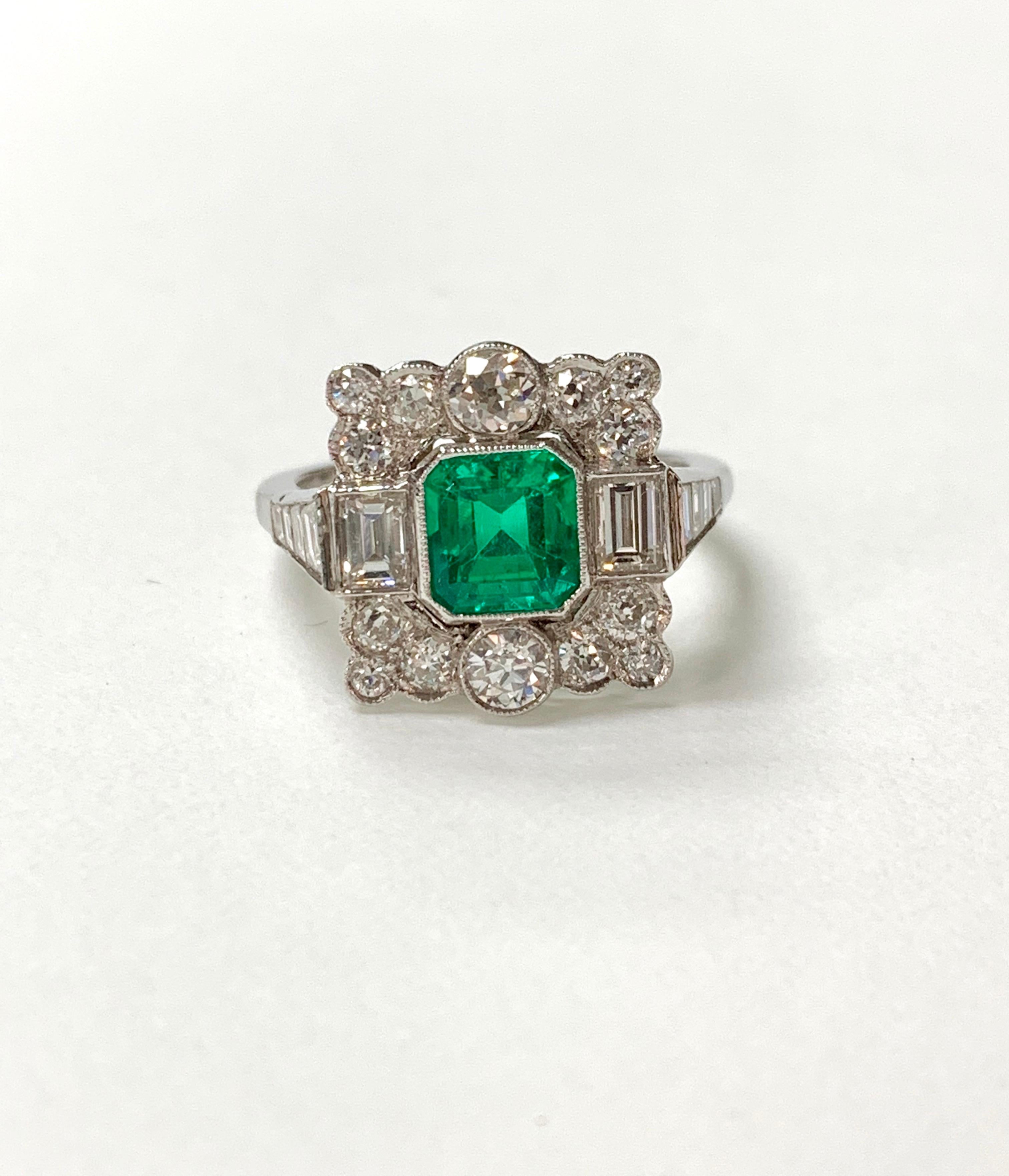 This gorgeous columbian emerald and diamond engagement ring is hand crafted in Platinum. 
The details are as follows : 
Emerald weight : 0.99 carat 
Diamond weight : 1.77 carat ( GH color and VS clarity ) 
Ring size : 6 1/4 
Metal : Platinum 