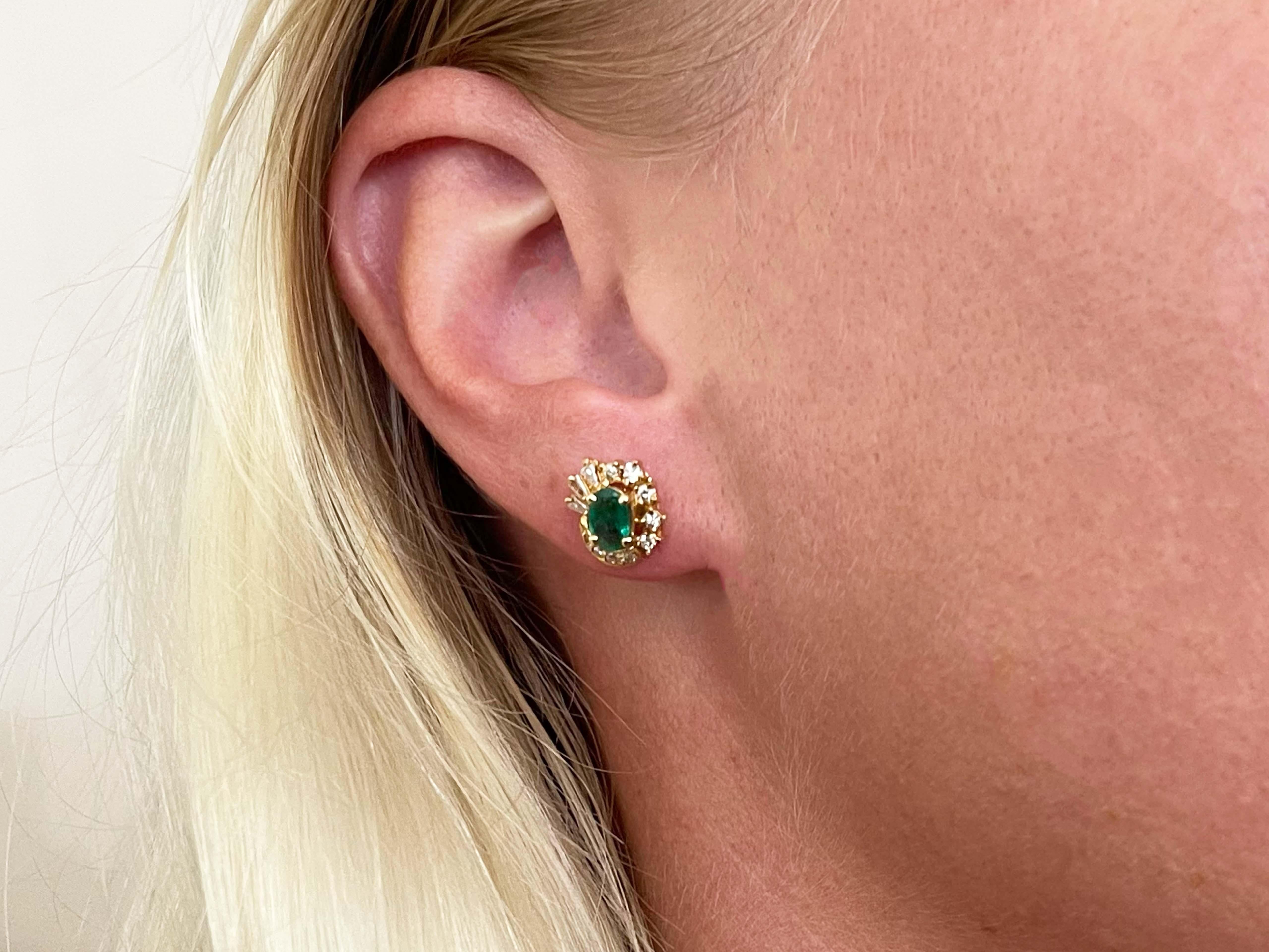 Earrings Specifications:

Metal: 18k Yellow Gold

Earring Measurements: 11.3 mm x 9 mm

Total Weight: 3.5 Grams

Emeralds: 2

Emerald Carat Weight: 0.70 carats
​
​Emerald Measurements: 6.02 mm x 3.98 mm x 2.20 mm

Diamonds: 18 round brilliant + 6