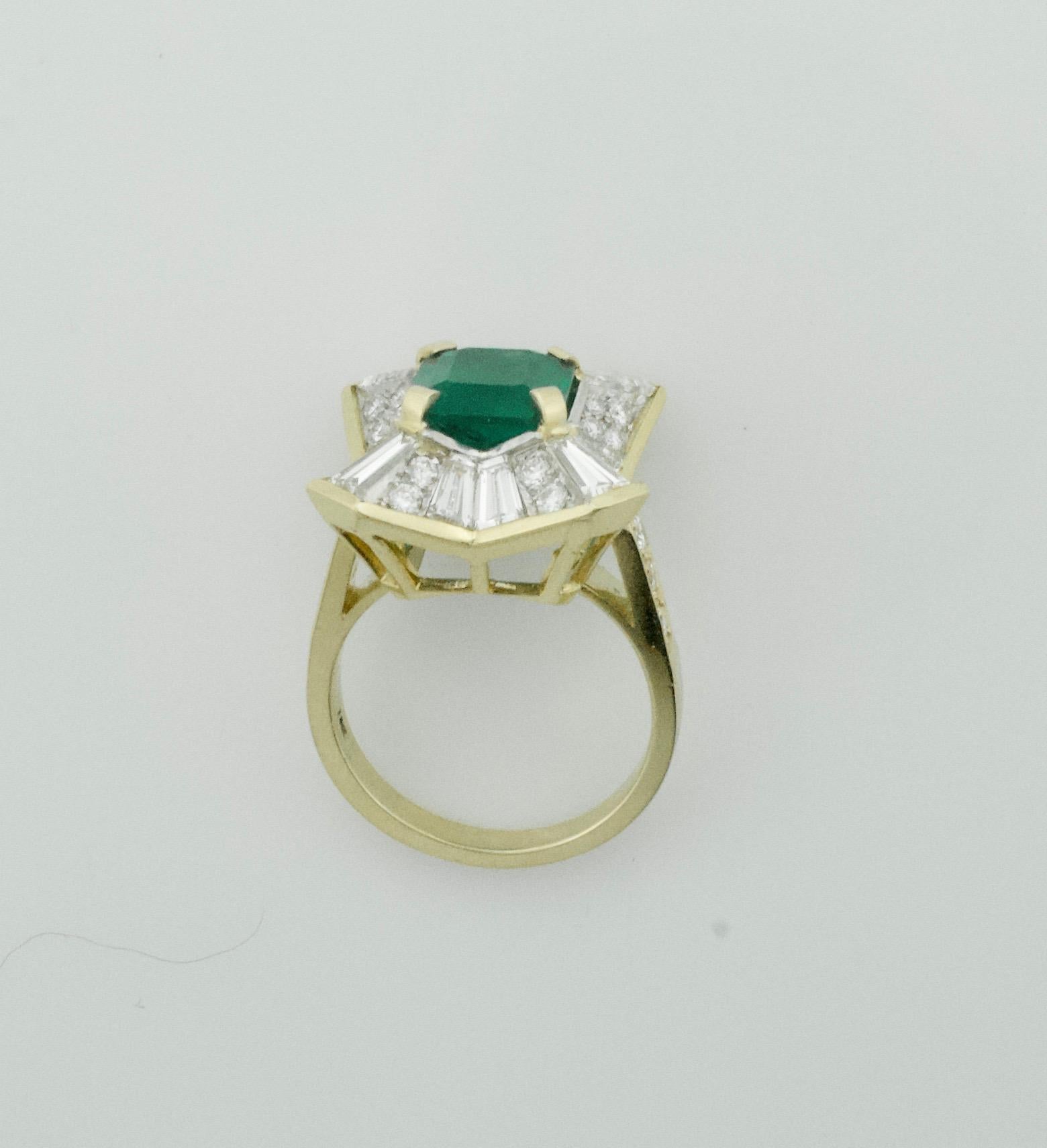 Colombian Emerald and Diamond Ring 3.27 with GIA Certification in 18k
One Emerald Cut Colombian Emerald  weighing 3.27 carats [Beautiful Colombian Color]
Twelve tapered Baguette Diamonds weighing 2.00 carats approximately
Thirty Round Brilliant Cut
