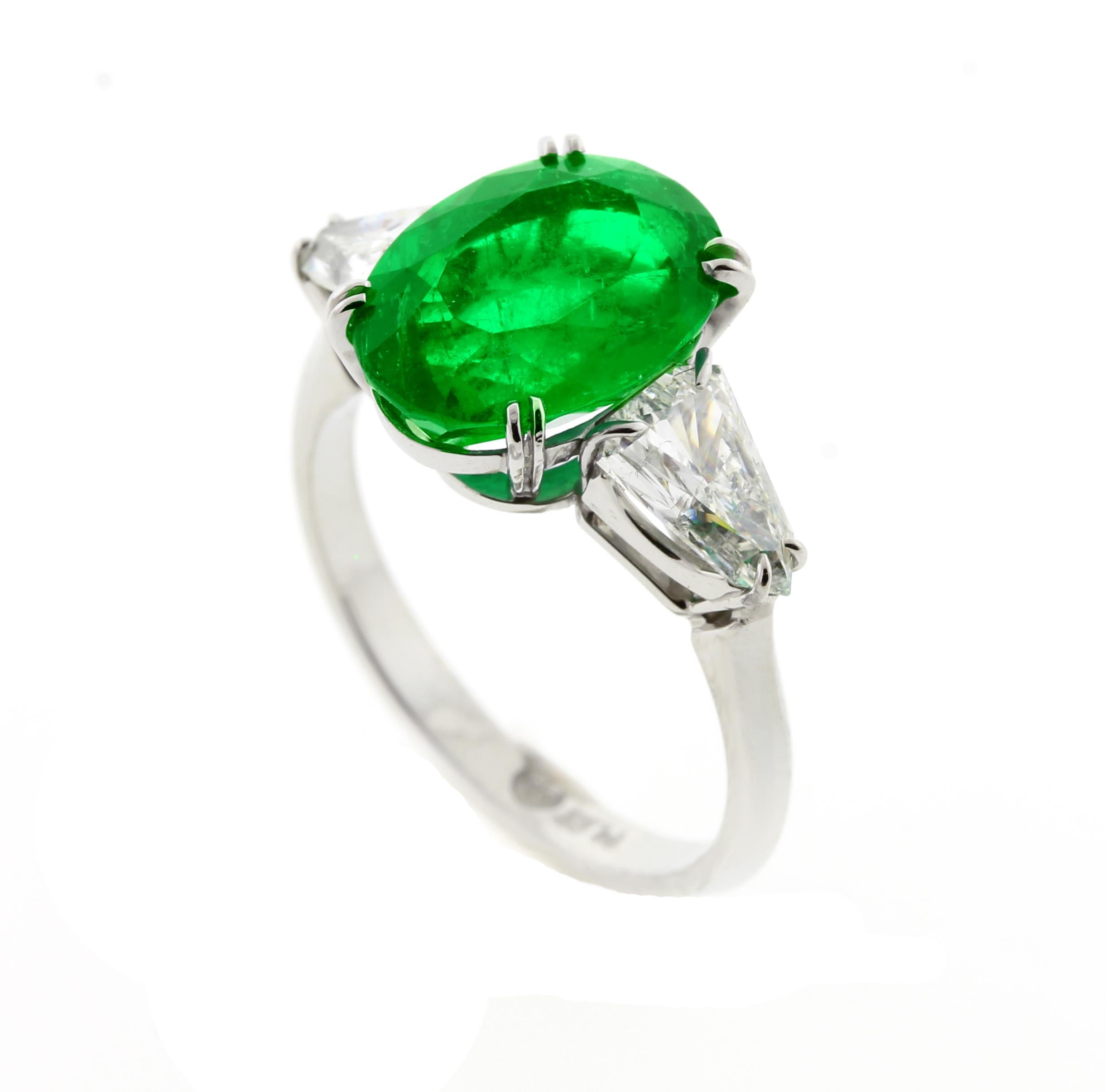 From the master ring makers of Pampillonia jewelers this certified oval emerald and shield cut  handmade diamond ring.  A.G.L has certified the emerald to be from Colombia with only minor (rare) enhancements.
♦ Designer: Pampillonia
♦ Metal: