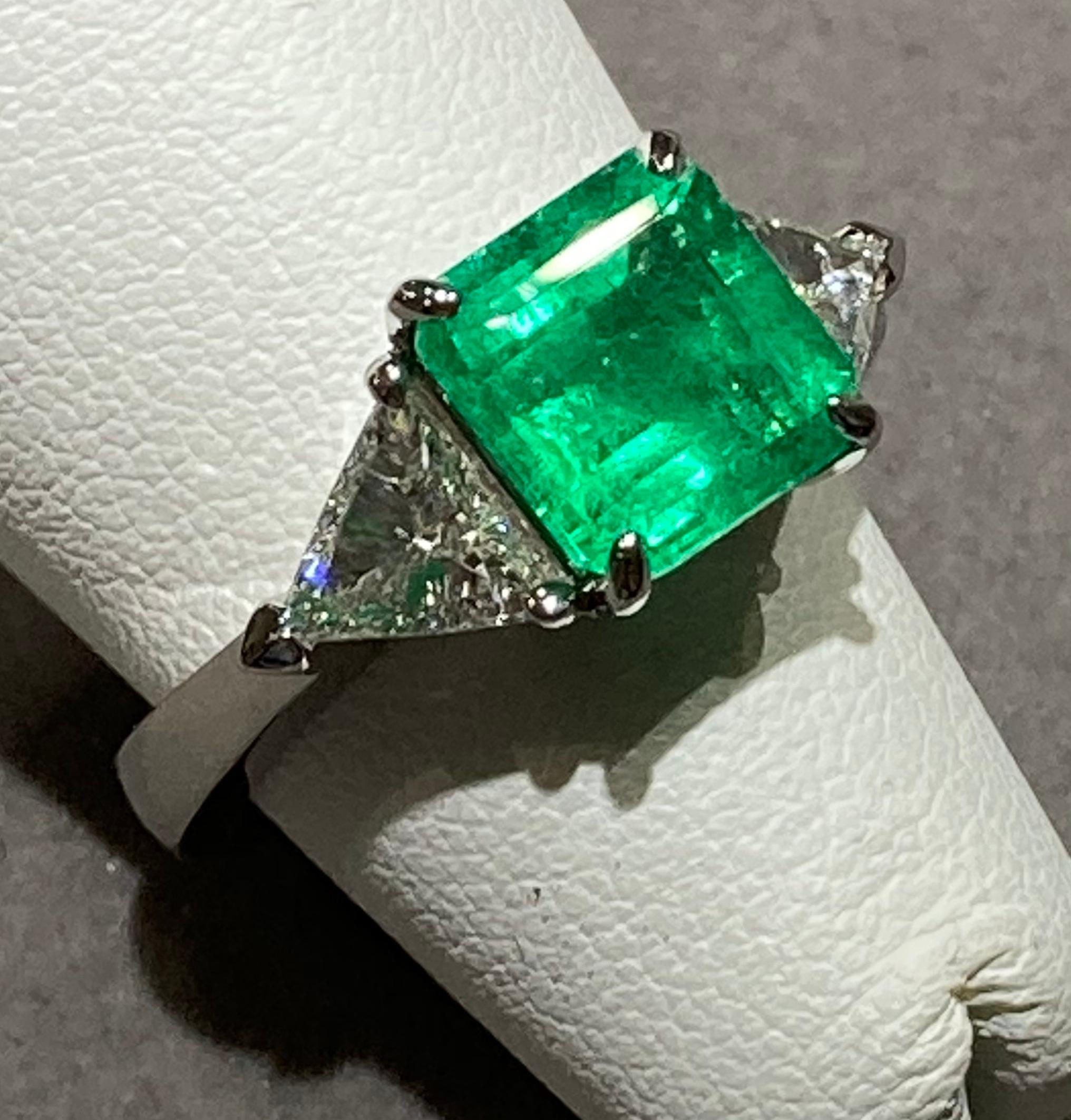 2.42ct Columbian emerald set along with two trillion cut diamonds of SI1-2 clarity and F color that total a weight of 0.80cts.

