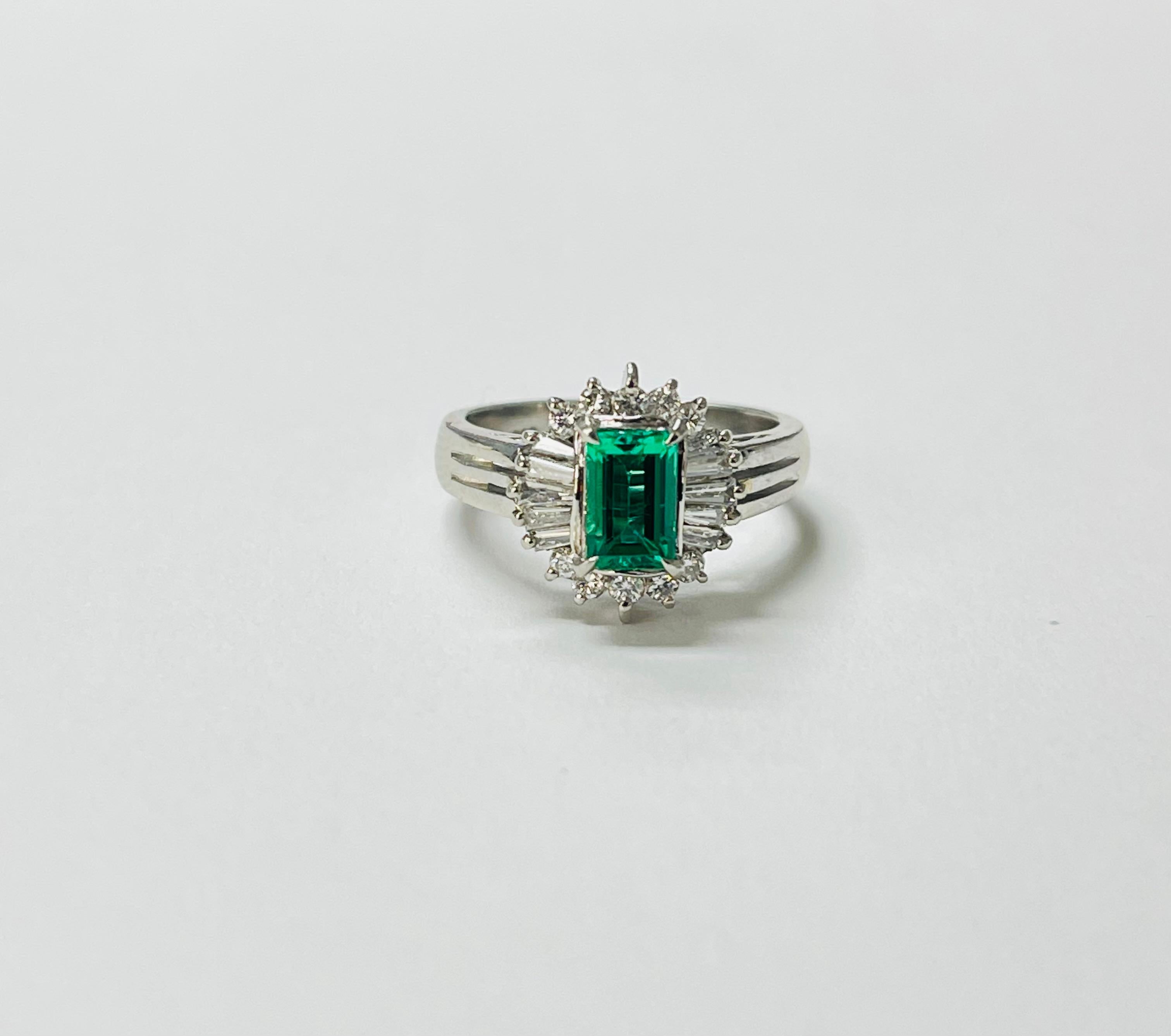 GIA Certified Columbian no oil emerald octagonal step cut and diamond engagement ring in platinum. 

The details are as follows : 

Emerald weight : 0.60 carats 
Origin : Columbia 
Treatment : None 
Diamond weight : 0.33 carats 
Metal : Platinum