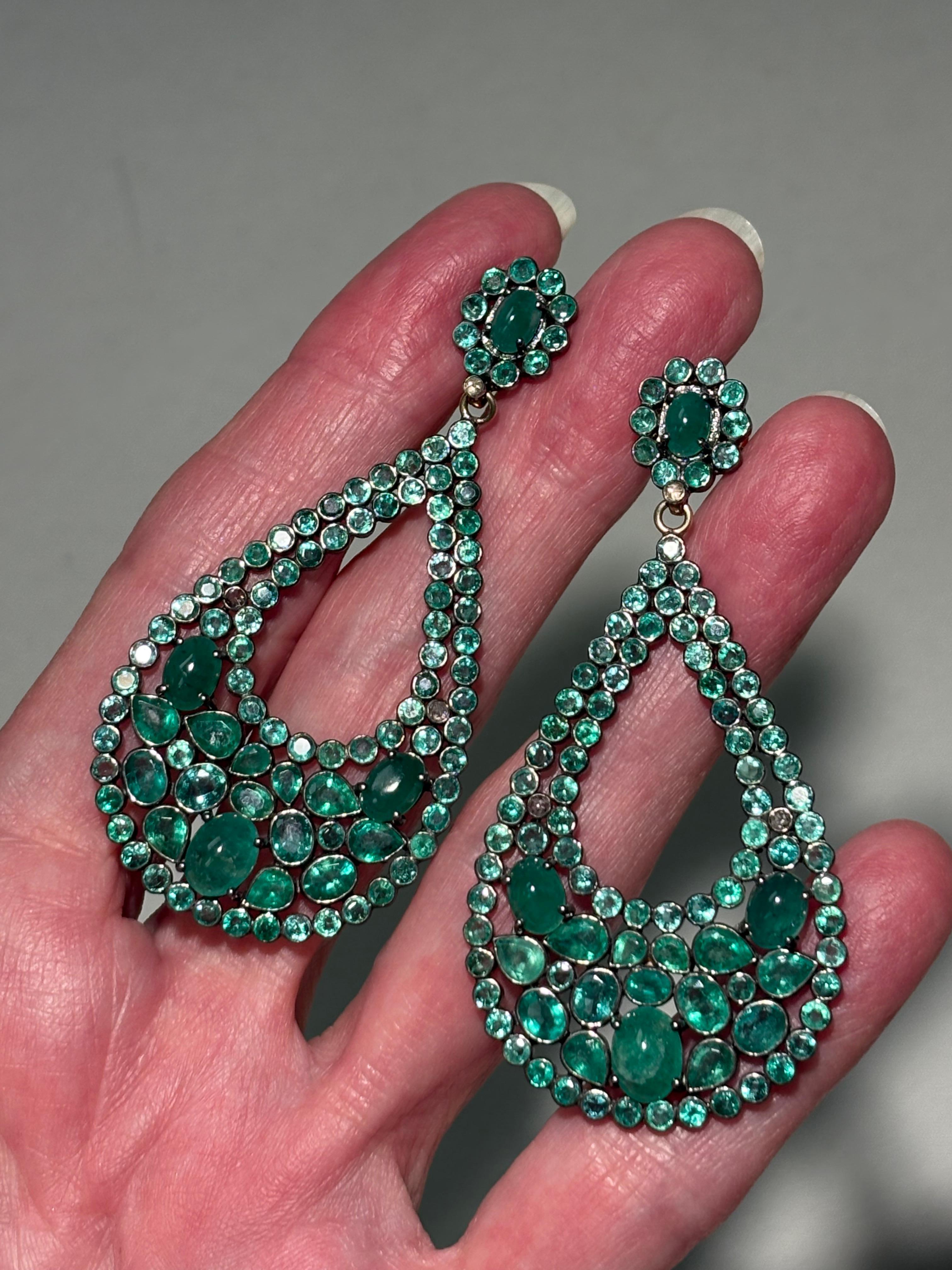 Description
Vibrant 24 carat Columbian Emerald earrings in a feminine pear-shape design, featuring a beautiful mix of  faceted and cabochon shapes and sizes with delicate diamond accents.
Item # E2785

Materials and Weight
Emeralds 24 carats,