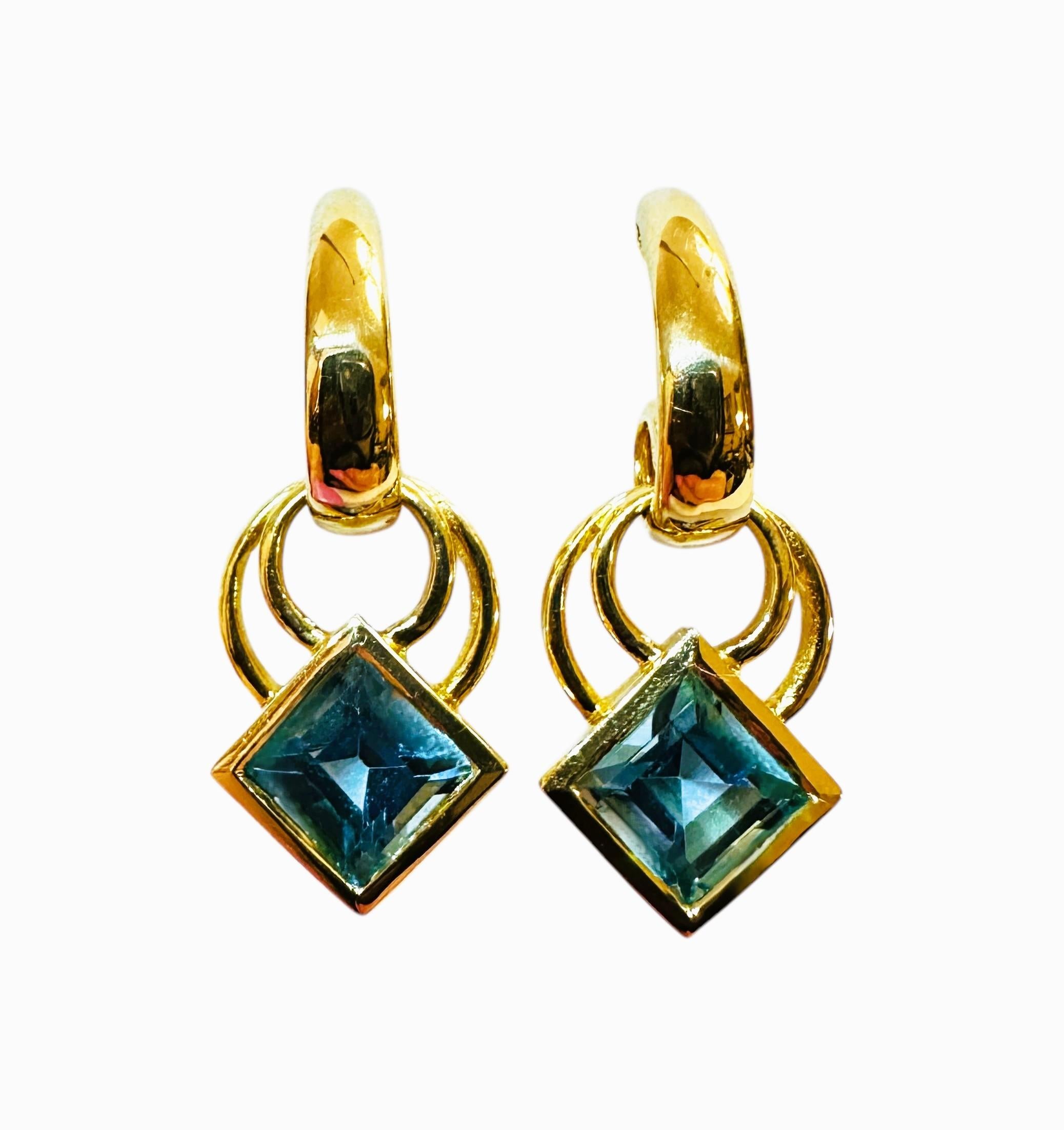 These earrings are just beautiful!  They are 14k yellow gold with Asscher cut Blue Topaz Stones.  Each stone measures 5 mm and it totals 1.42 for both earrings.  They are beautifully made by Columbian Emeralds International and stamped 