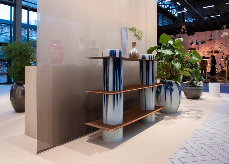 Porcelain cylinders and corten steel plates form the basic elements of this series, with which it is possible to create shelving, side tables, low tables and stools. The porcelain parts are hand thrown, trimmed, glazed and fired at 1300 C by the