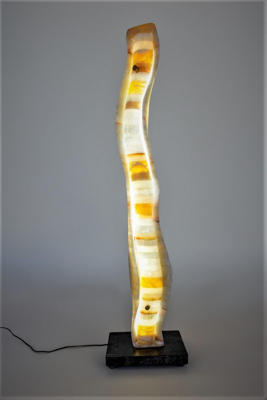 Illuminated sculpture composed of laminated alabaster using an additive (laminated) rather than the more traditional subtractive process of carving from a single block of stone. Individual prefabricated pieces of alabaster are glued together using