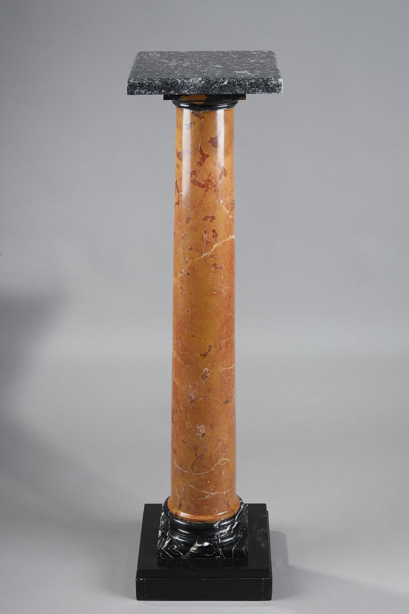 Marble column with a cylindrical shaft in red Pyrenean marble resting on a square base in grey Sainte Anne marble, on a black marble base. The swivel top is also in gray Sainte Anne marble. 