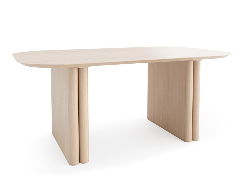This spacious table is built on two pillars, each one shaped by the soft curves of inverted flutes, mimicking a gateway with an open and inviting form.

Available in three colors.

Architect CARLOS MEZA holds a B.A. from Javeriana University in