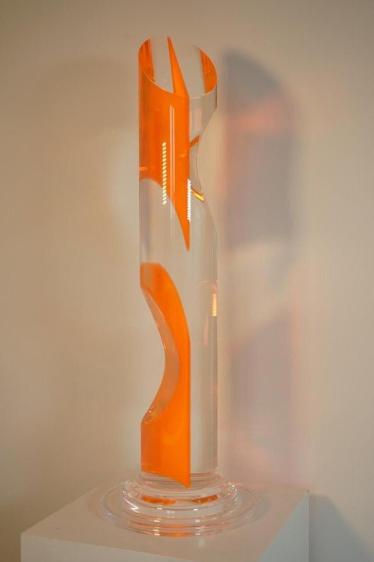 Transparent and orange plexiglass sculpture.
Base size: Diameter 36 cm.
 