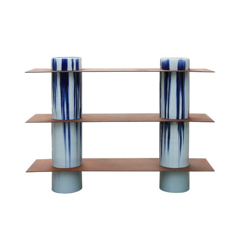 Column shelving, High by WL CERAMICS
Design: David Derksen
Materials: Porcelain with blue dripping glaze, corten steel
Dimensions: 110 x 25 (ceramic ), 150 x 40 x 110 cm

Also Available: Column Shelving Low.

Porcelain cylinders and corten