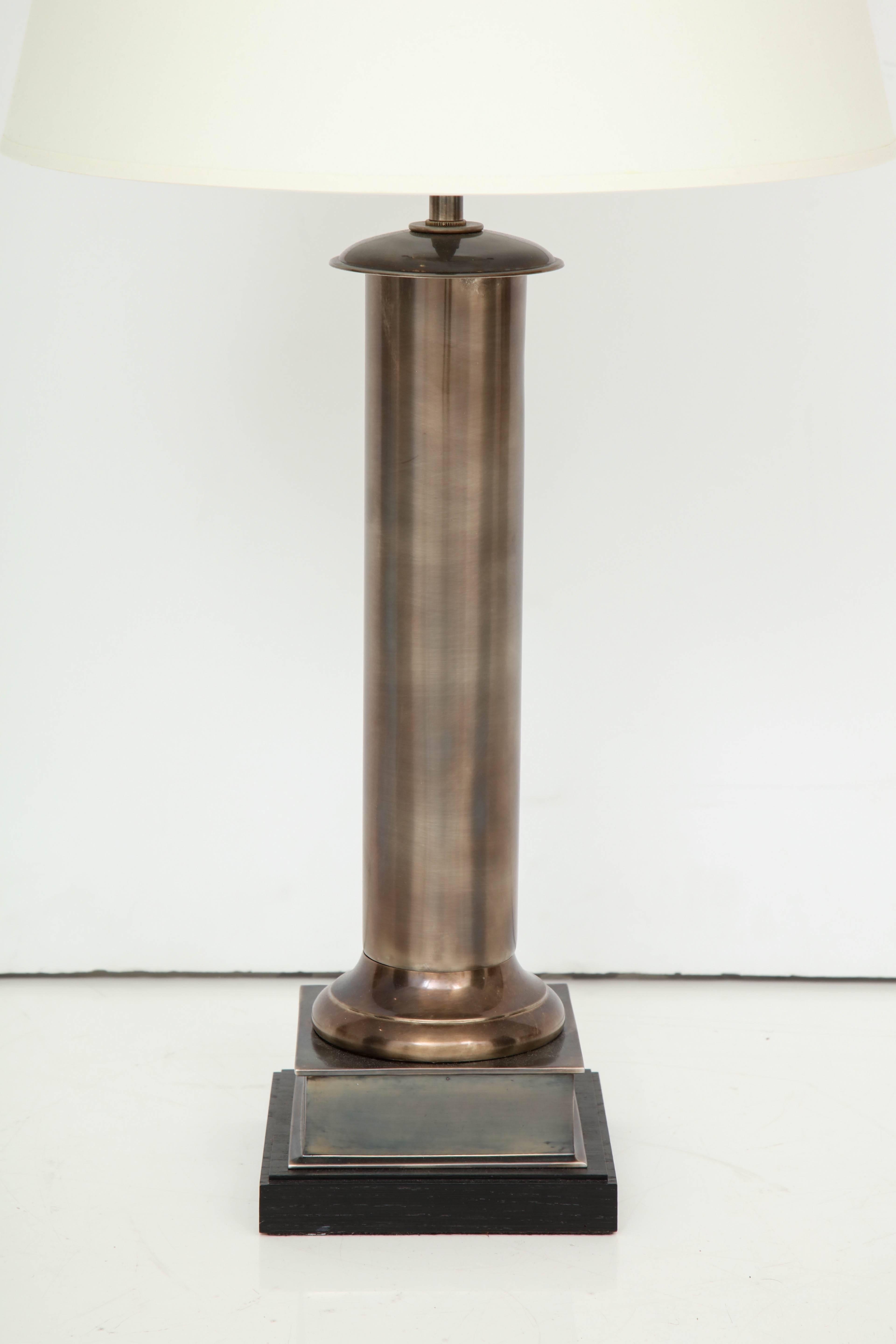 Brass column table lamp in burnished antique nickel finish with ebonized oak base.