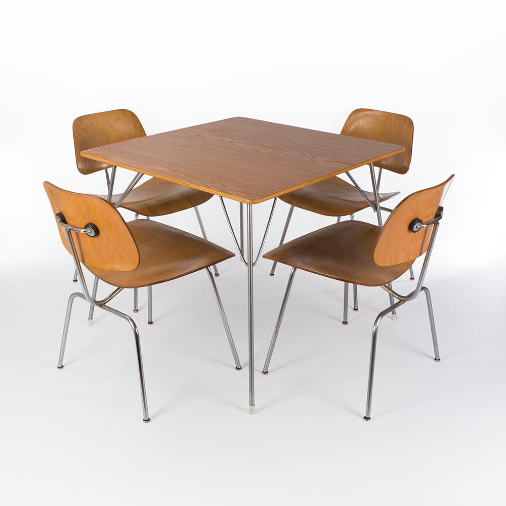 This set comprises of an original Evans Eames DTM-2 square 'Drop-Table' in Calico Ash and a matching set of 4 Evans Eames DCM molded plywood dining chairs. The table top is in exceptional condition for its age and so are the chairs.