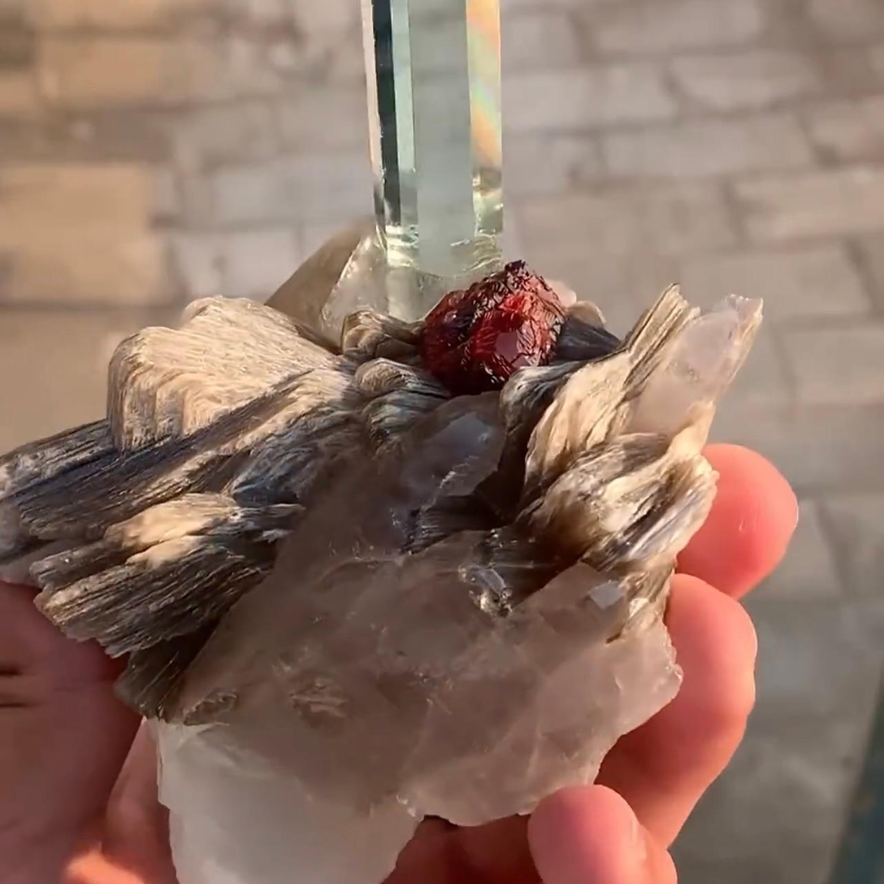 Product Information:

Specimen Name: Aquamarine with Quartz and Garnet
Weight: 329 grams
Dimension: H: 11.2 x W: 9.5 x D: 5.6 cm
Treatment: Aquamarine Repaired 
Origin: Shingus Mine, Roundu District, Gilgit Baltistan Province, Pakistan