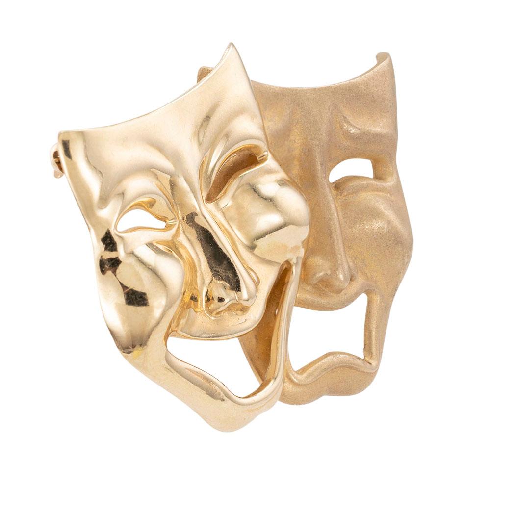 Yellow gold comedy and tragedy theater masks brooch circa 1990. 

SPECIFICATIONS:

METAL:  14-karat yellow gold high polish and matte finishes.

WEIGHT:  16.1 grams.

MEASUREMENTS:  approximately 1-7/8” (4.80 cm) horizontal width and 1 1/2” (3.08