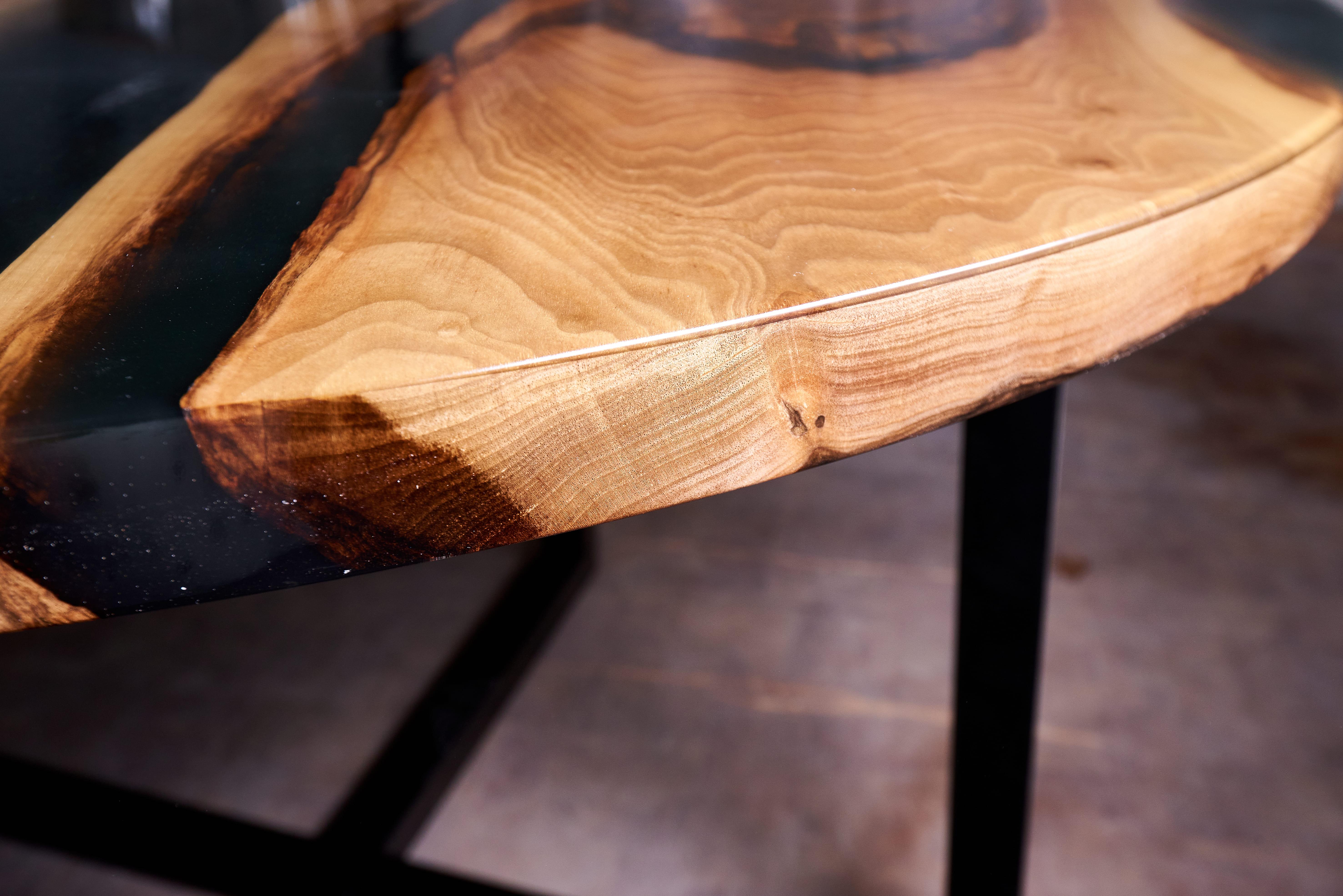 Two flashes of light in the darkness. Two comets that will meet only once for a short time. After that they will part forever. A short but priceless moment.

Table in antique dark walnut and black epoxy slabs. Coated with glossy hard lacquer for