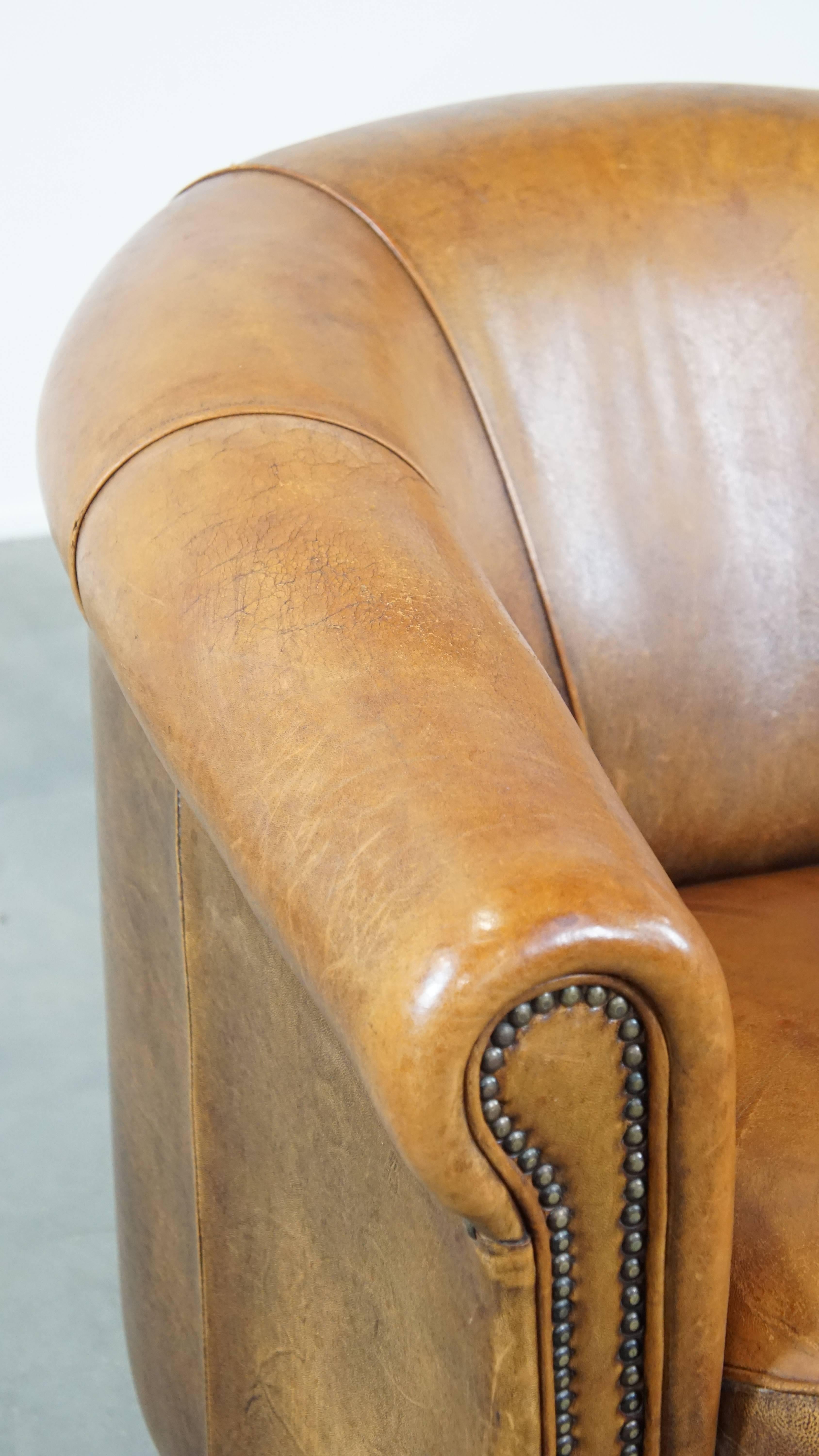 Comfortable and charming, sturdy sheep leather club armchair in a cognac color For Sale 4
