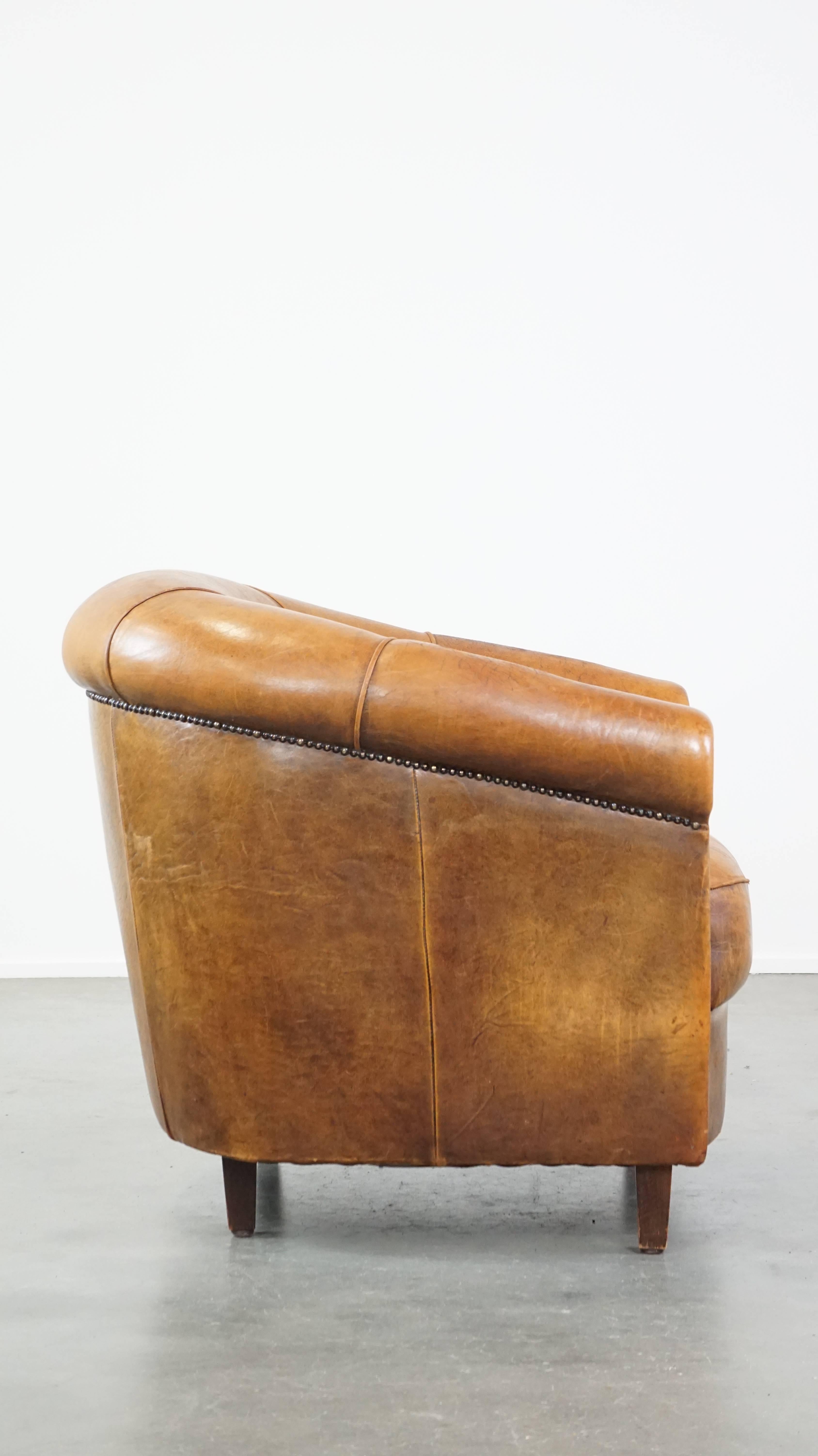 Hand-Crafted Comfortable and charming, sturdy sheep leather club armchair in a cognac color For Sale