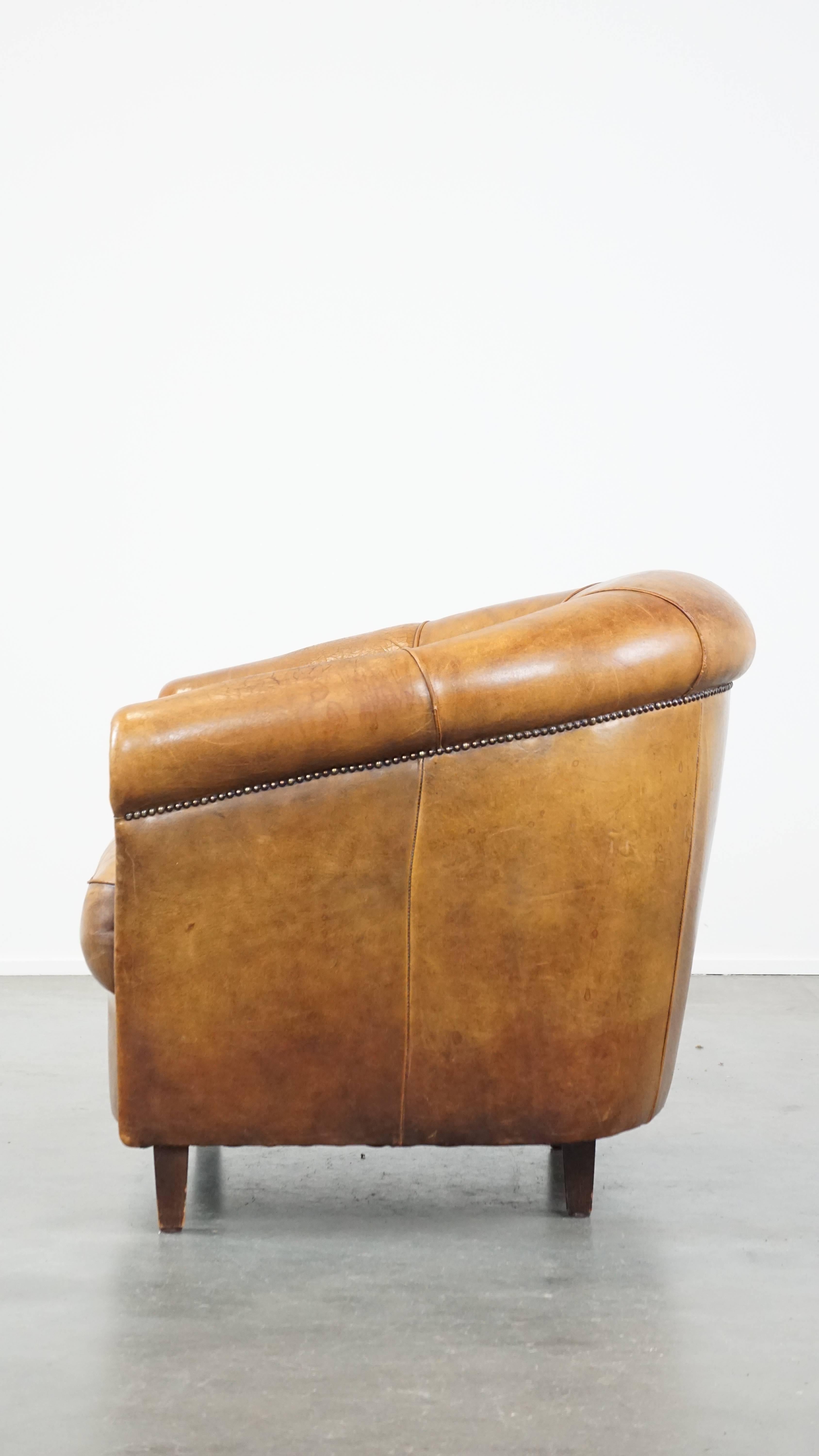 20th Century Comfortable and charming, sturdy sheep leather club armchair in a cognac color For Sale