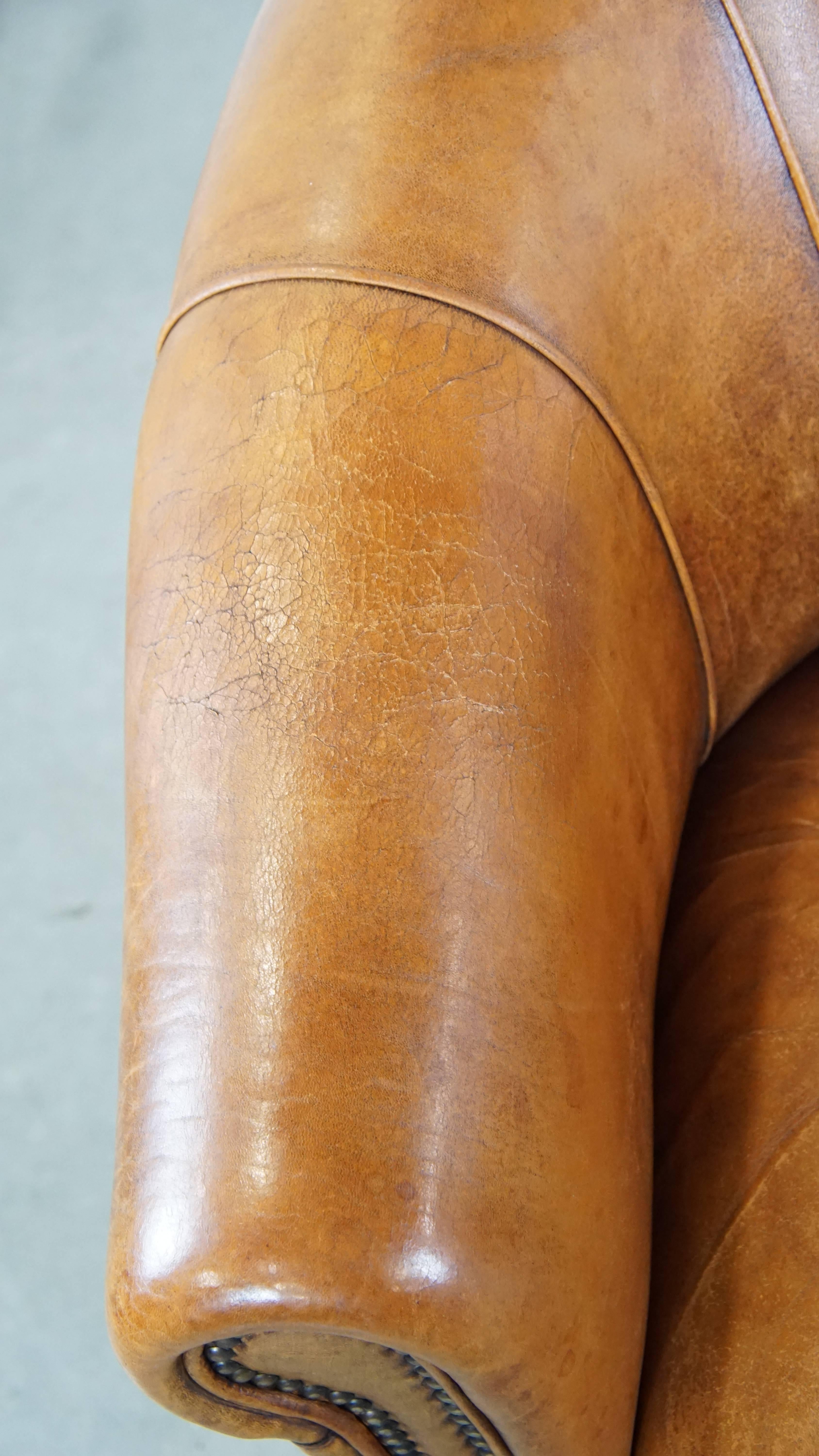 Comfortable and charming, sturdy sheep leather club armchair in a cognac color For Sale 1