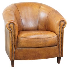 Comfortable and charming, sturdy sheep leather club armchair in a cognac color