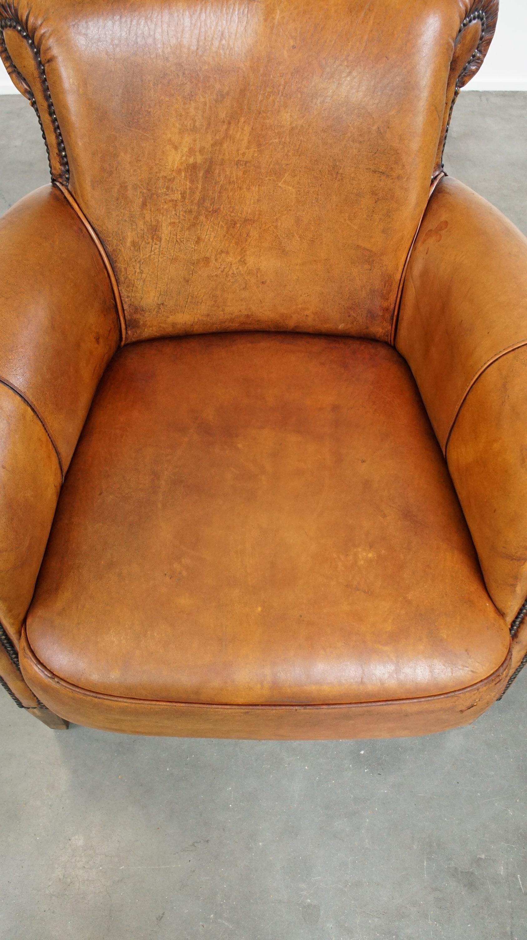Sheepskin Comfortable armchair made of sheepskin leather finished with decorative nails For Sale