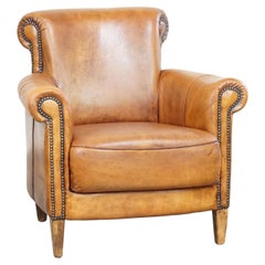 Comfortable armchair made of sheepskin leather finished with decorative nails