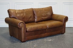 COMFORTABLE BROWN LEATHER TWO TO THREE SEATER SOFA WiTH FEATHER BACK CUSHIONS