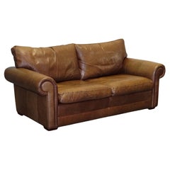 Vintage COMFORTABLE BROWN LEATHER TWO TO THREE SEATER SOFA WiTH FEATHER BACK CUSHIONS