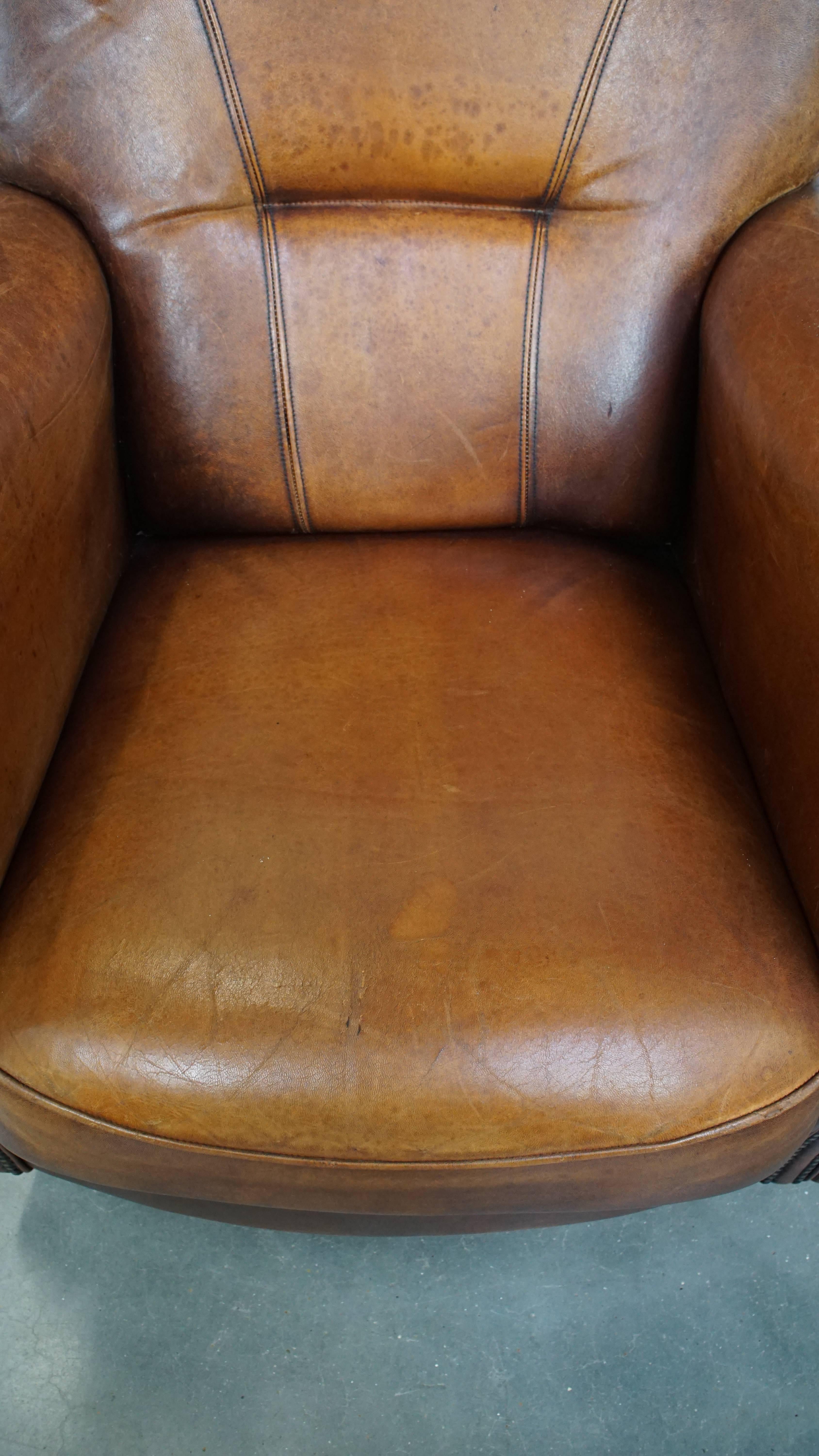 Classical Roman Comfortable Characteristic Sheepskin Leather Armchair with a Stunning Patina For Sale