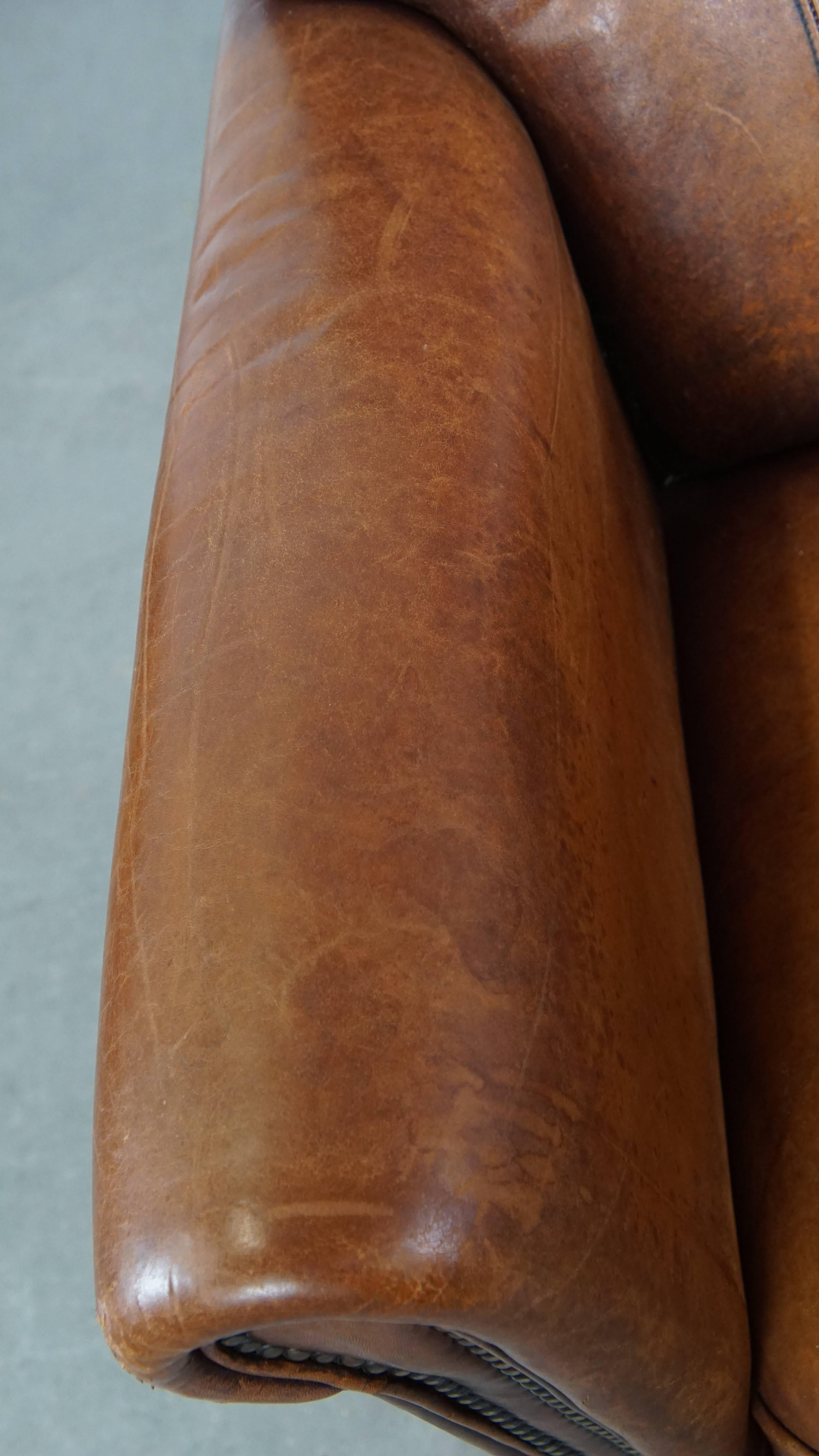 Hand-Crafted Comfortable Characteristic Sheepskin Leather Armchair with a Stunning Patina For Sale