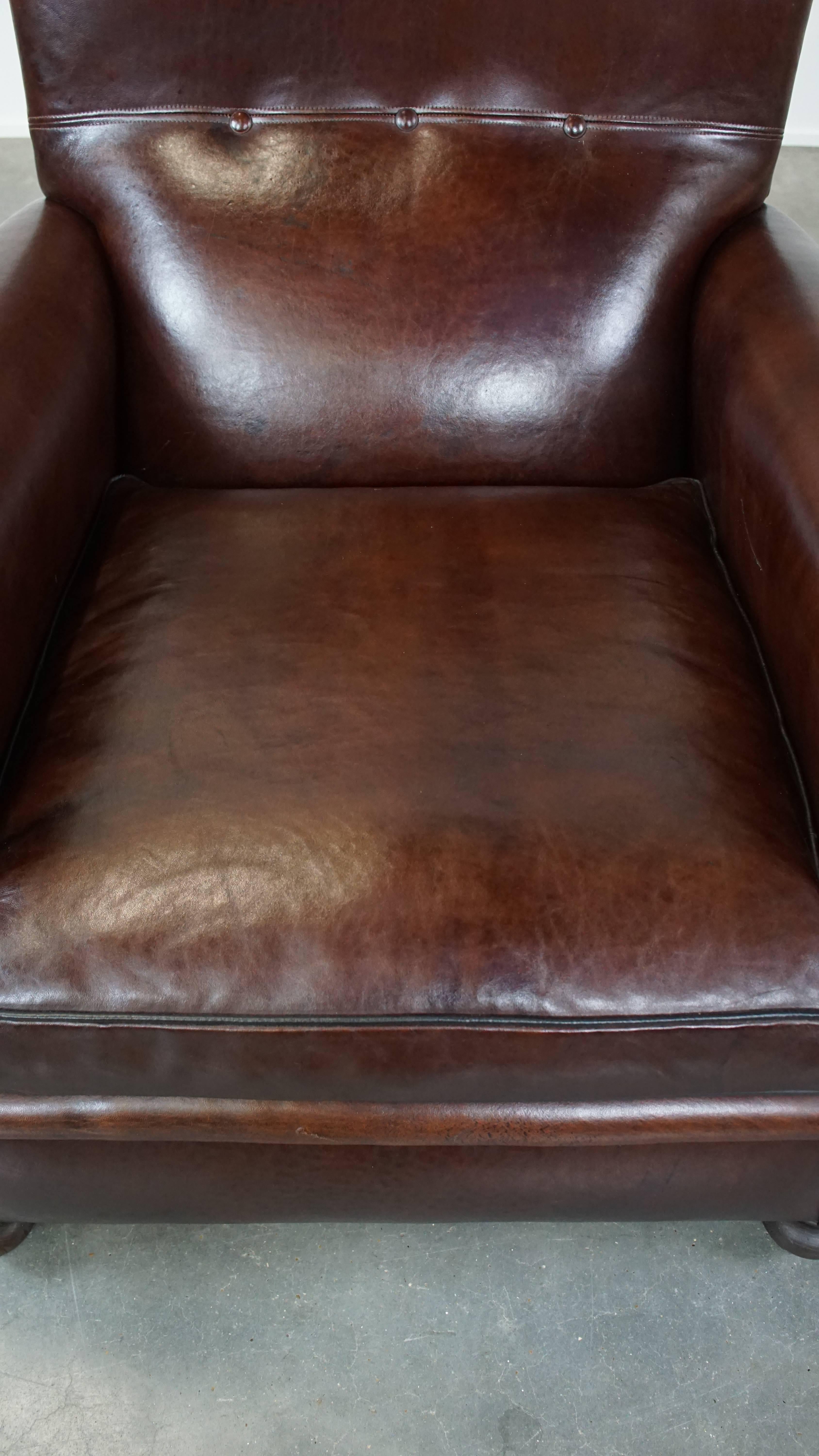Sheepskin Comfortable, classic dark antique sheepskin English armchair in good condition For Sale