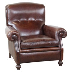 Comfortable, classic dark Antique sheepskin English armchair in good condition