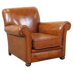 Comfortable cognac-colored antique sheep leather armchair with a nice appearance