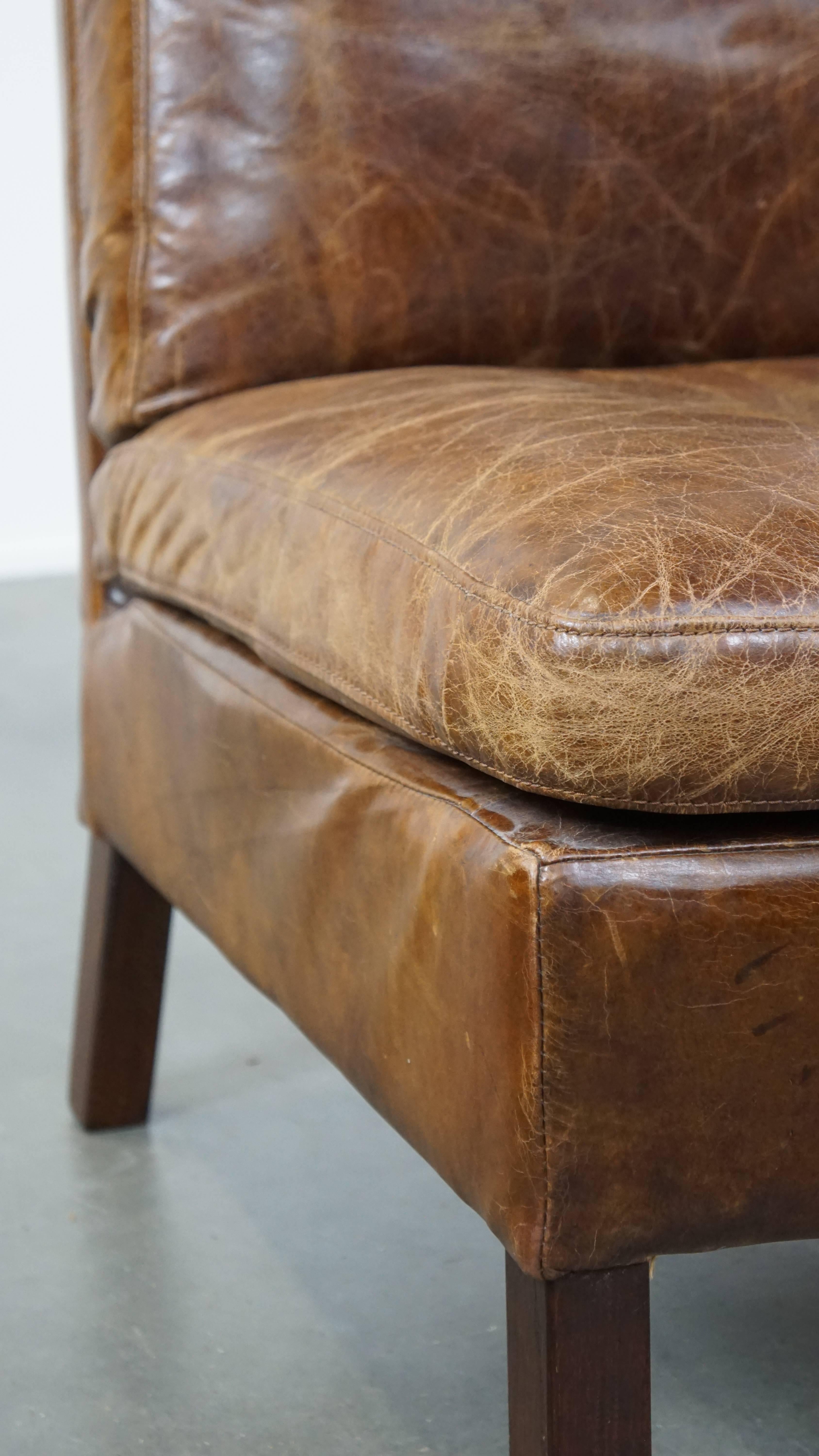 Comfortable cow leather lounge chair with a unique design and beautiful patina For Sale 2