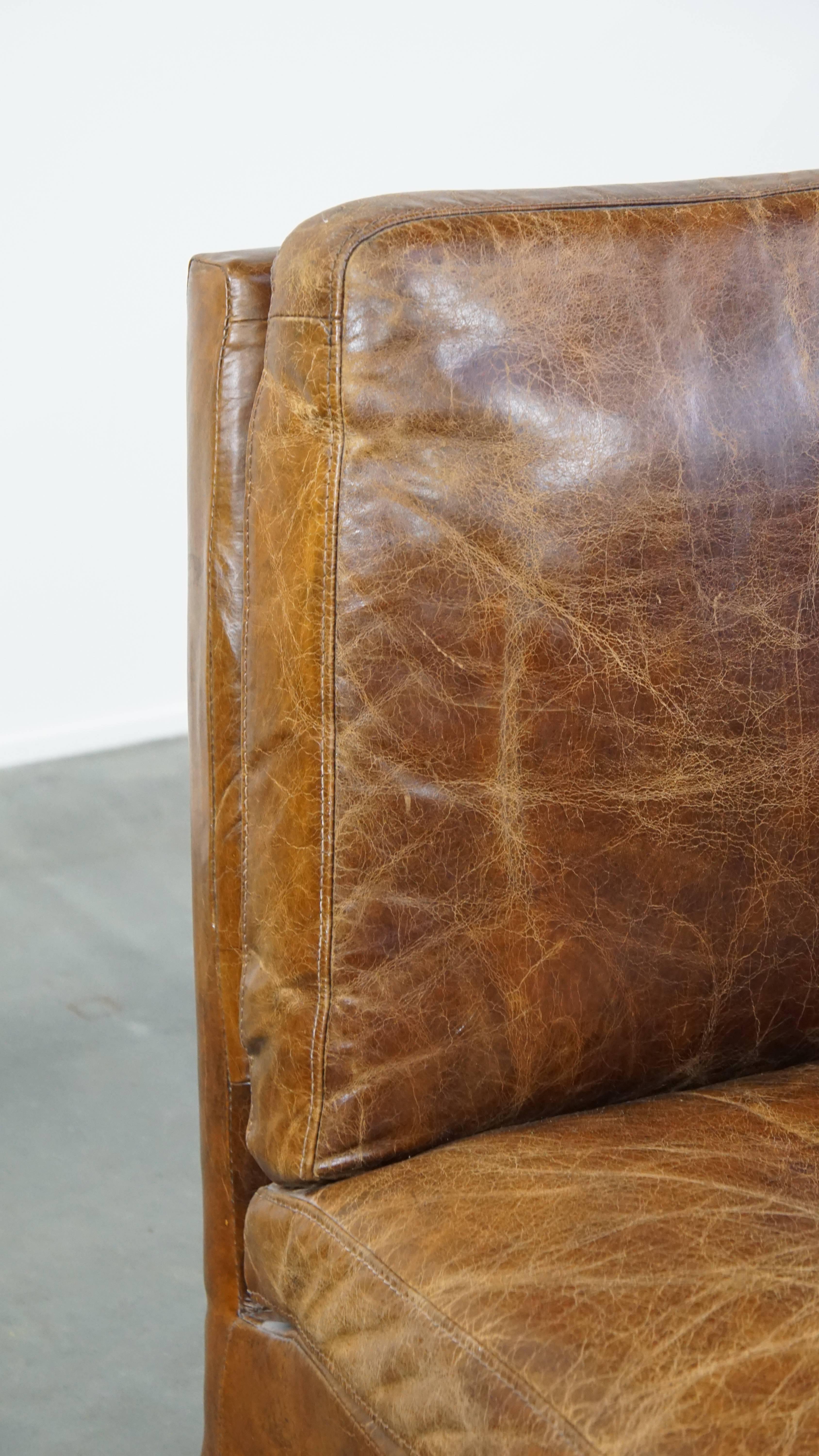Comfortable cow leather lounge chair with a unique design and beautiful patina For Sale 3