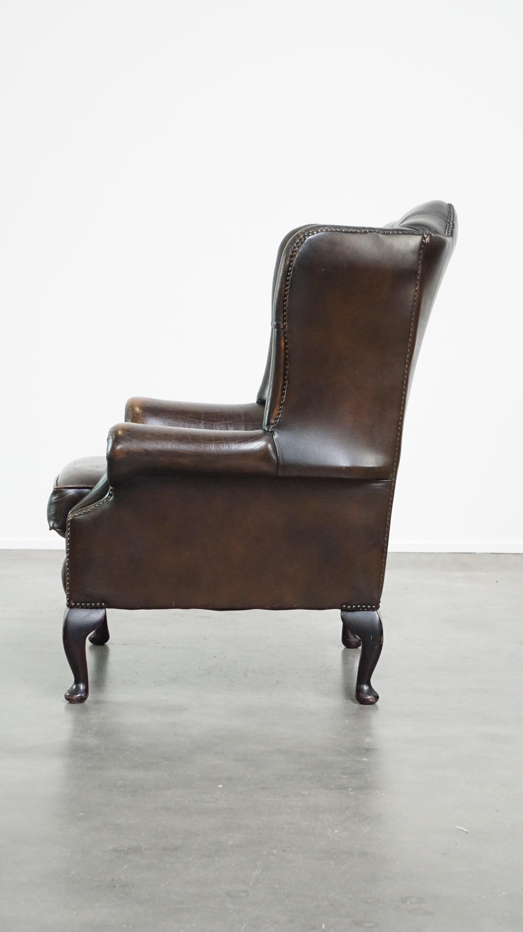 Comfortable dark brown vintage leather English chesterfield armchair