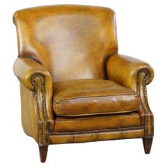 Comfortable large yellow English-style leather armchair with a fine finish