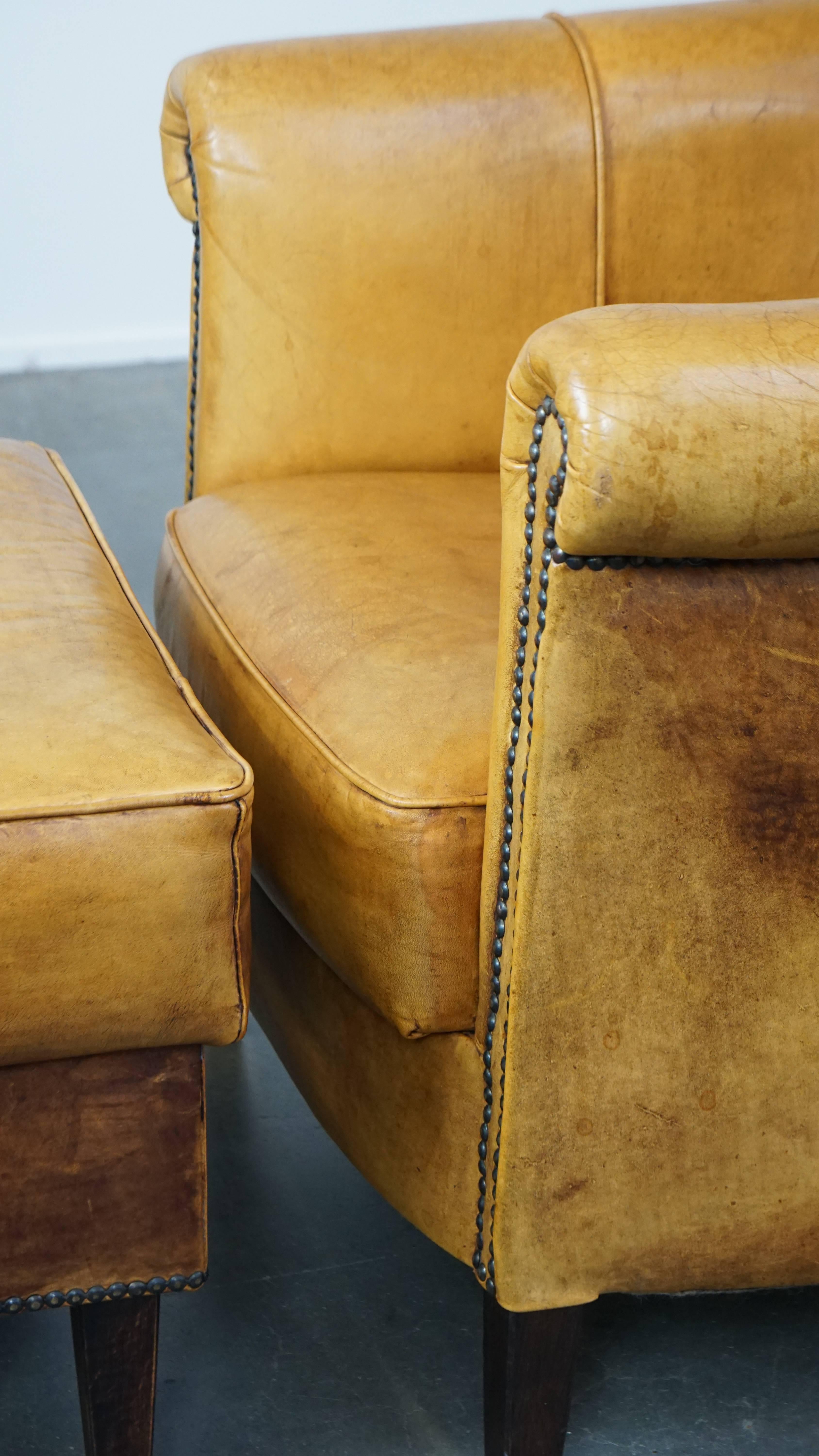 Comfortable leather armchair with ottoman, finished with decorative nails For Sale 4