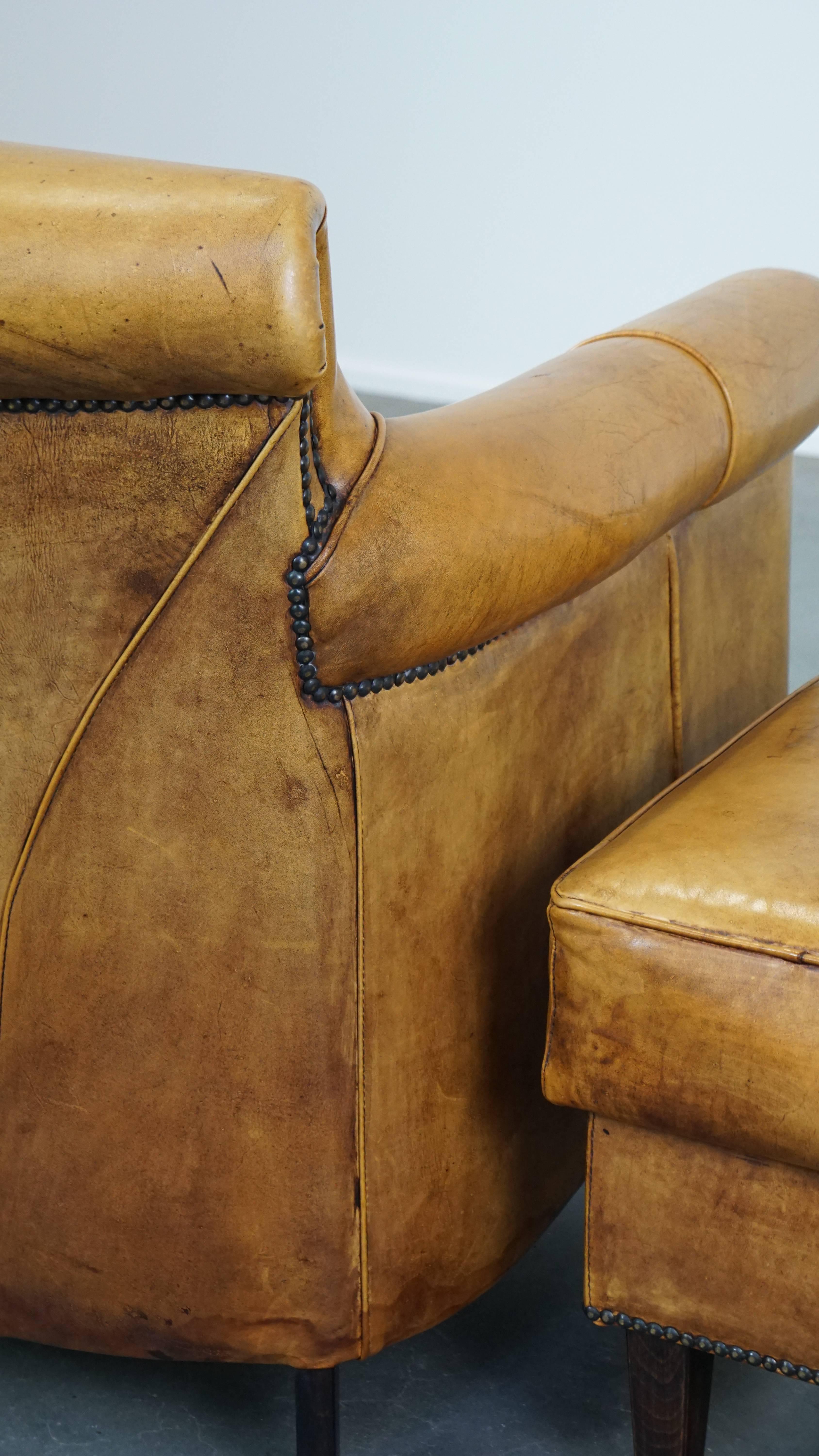 Comfortable leather armchair with ottoman, finished with decorative nails For Sale 5