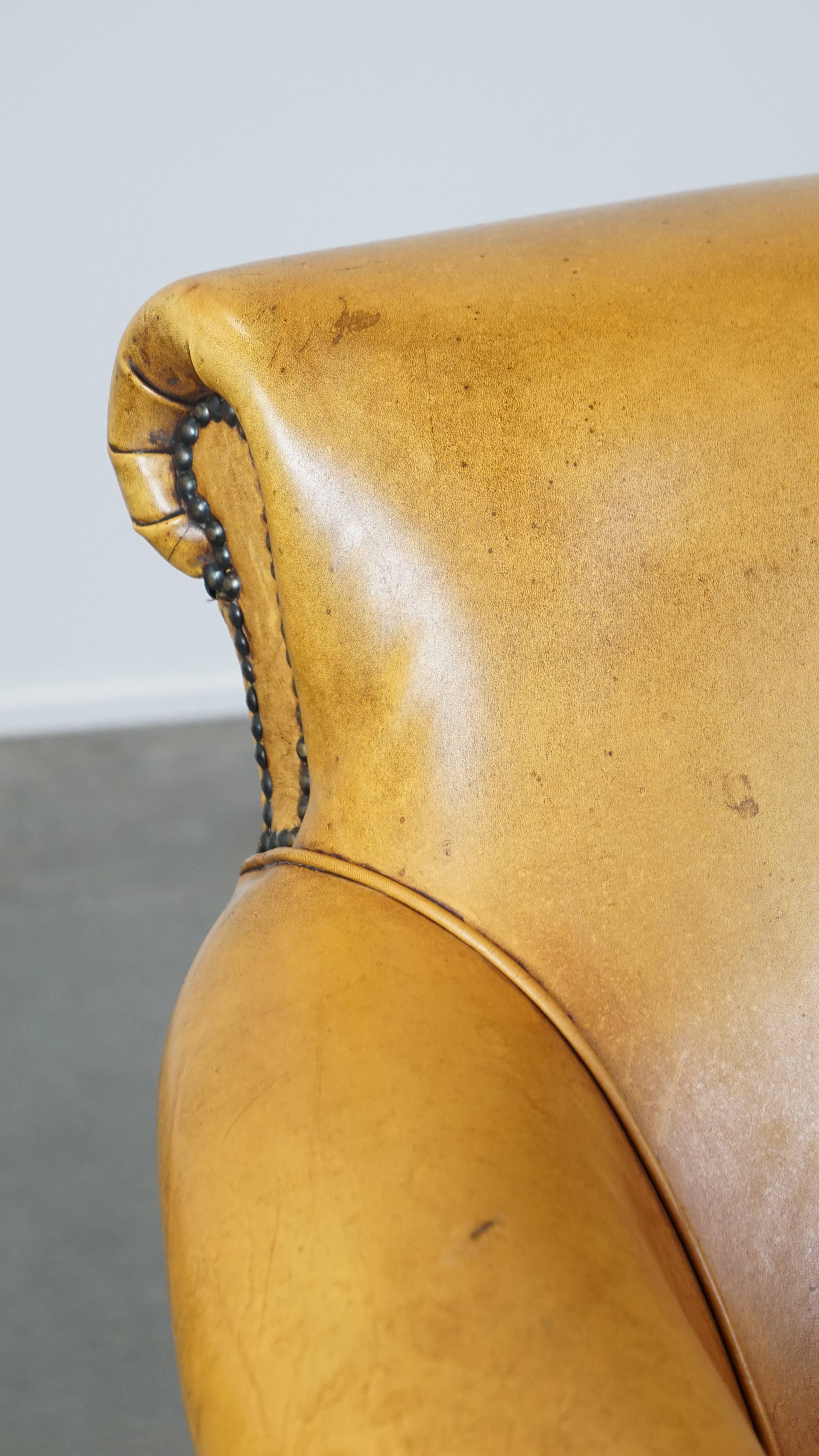 Comfortable leather armchair with ottoman, finished with decorative nails For Sale 6
