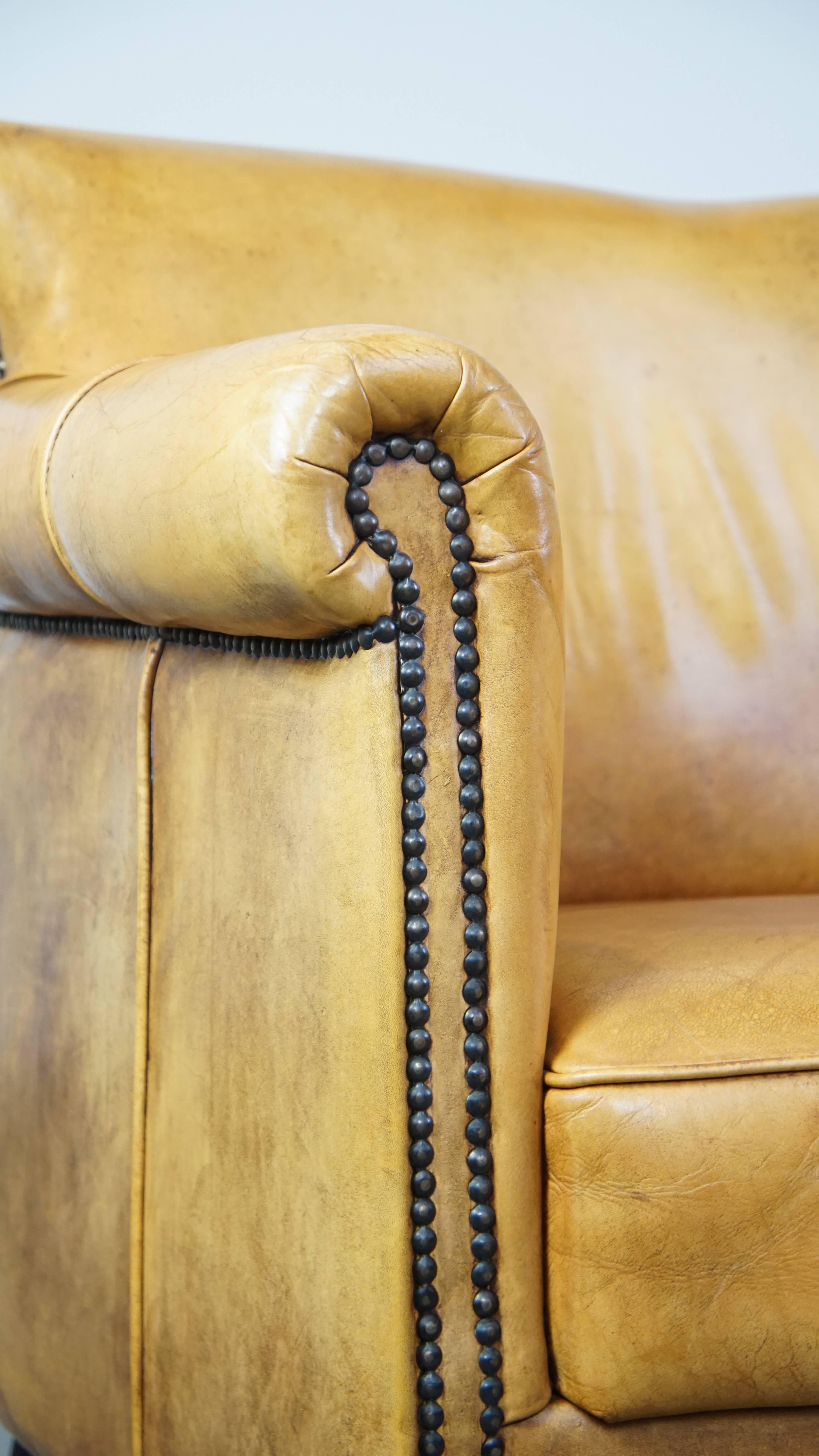 Comfortable leather armchair with ottoman, finished with decorative nails For Sale 8