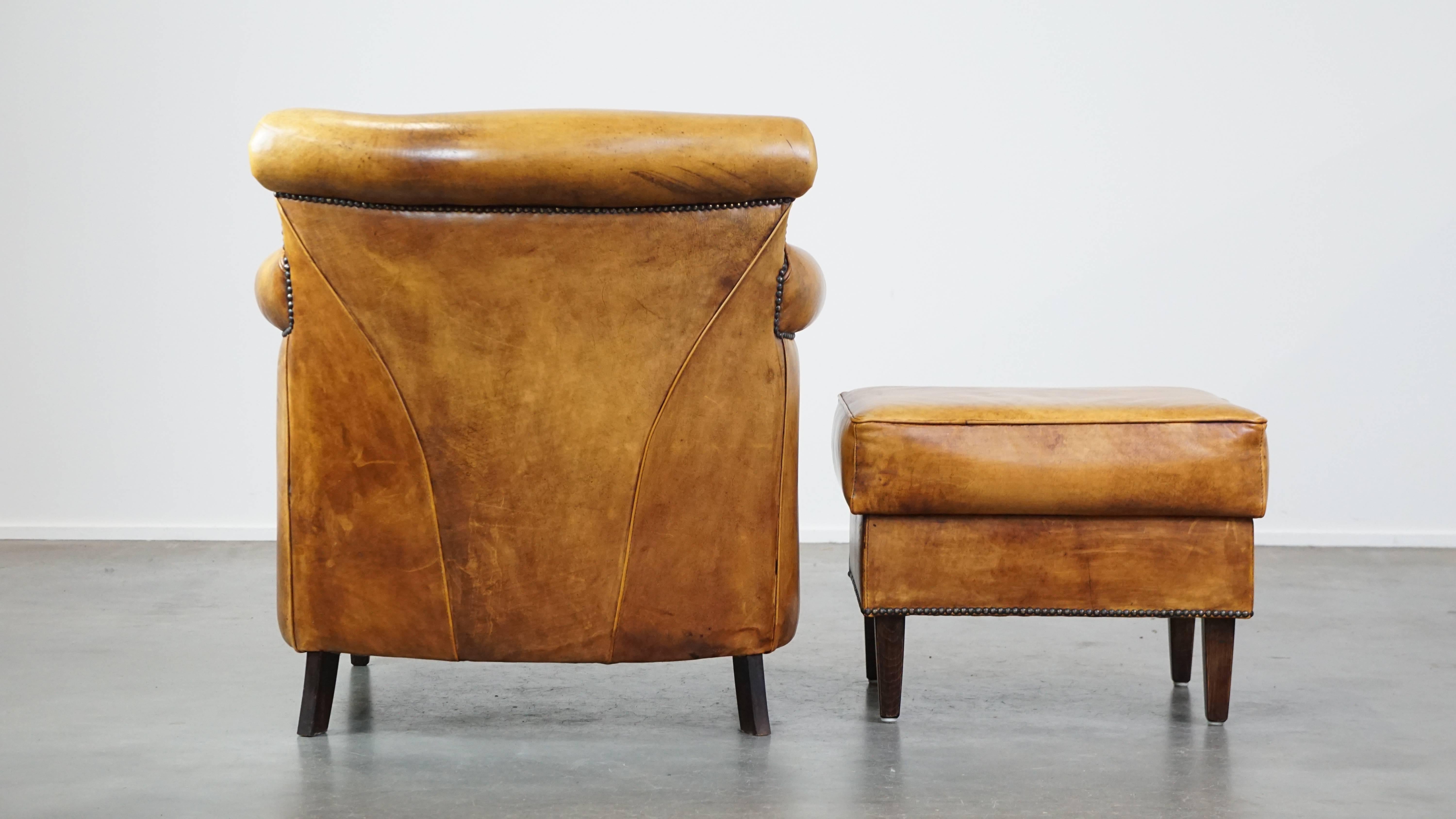 Comfortable leather armchair with ottoman, finished with decorative nails In Good Condition For Sale In Harderwijk, NL