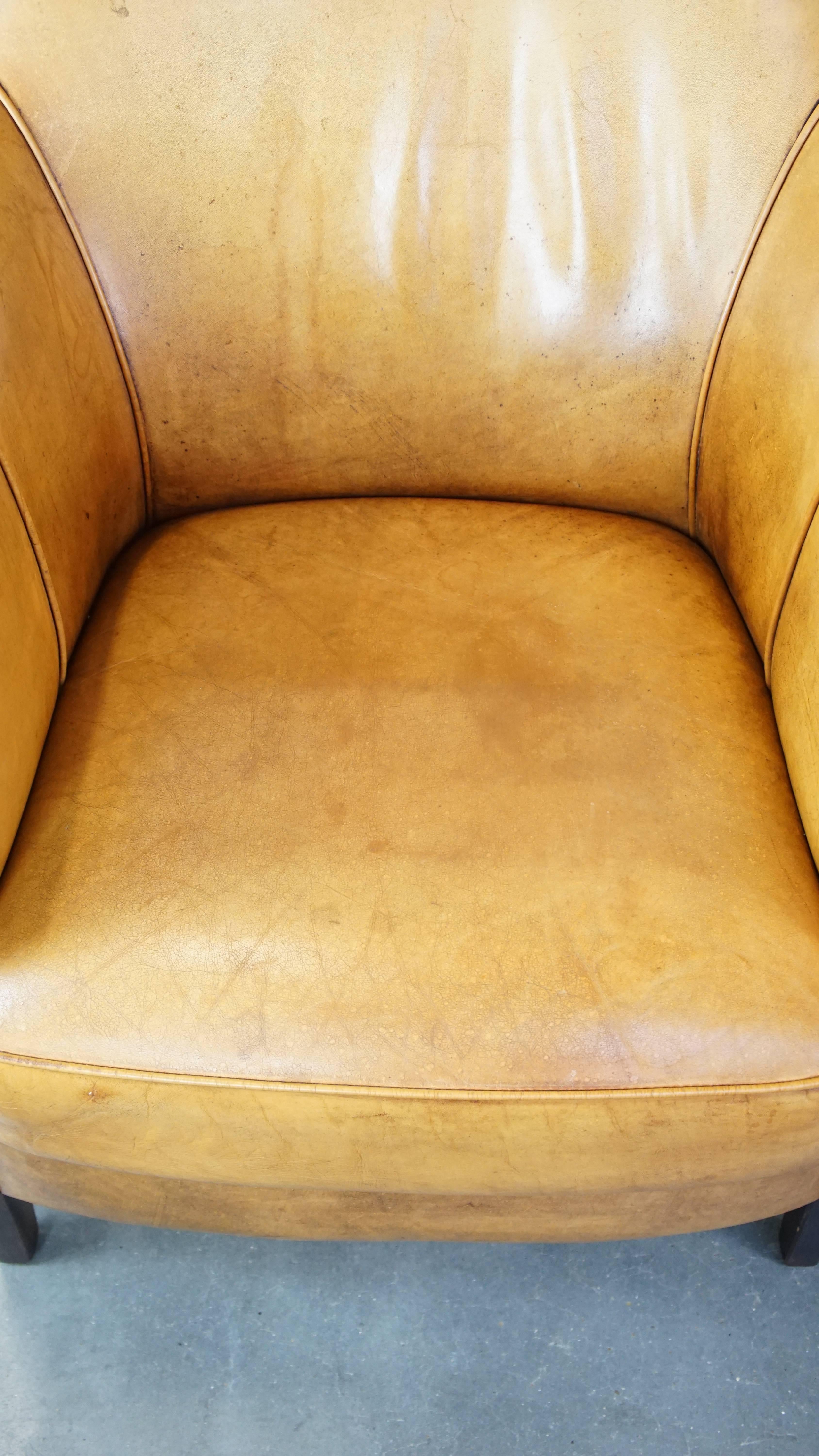Comfortable leather armchair with ottoman, finished with decorative nails For Sale 1