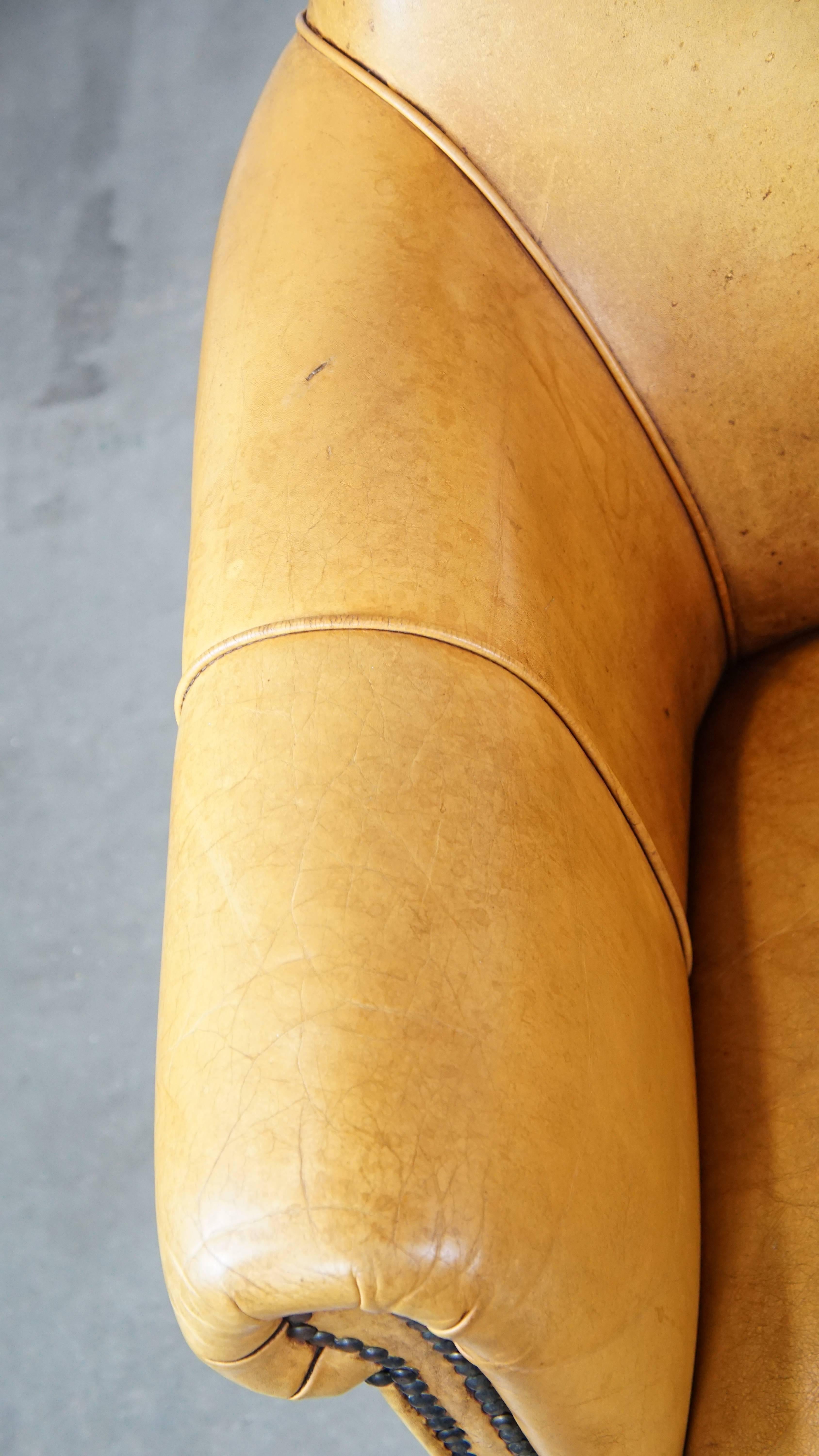 Comfortable leather armchair with ottoman, finished with decorative nails For Sale 2