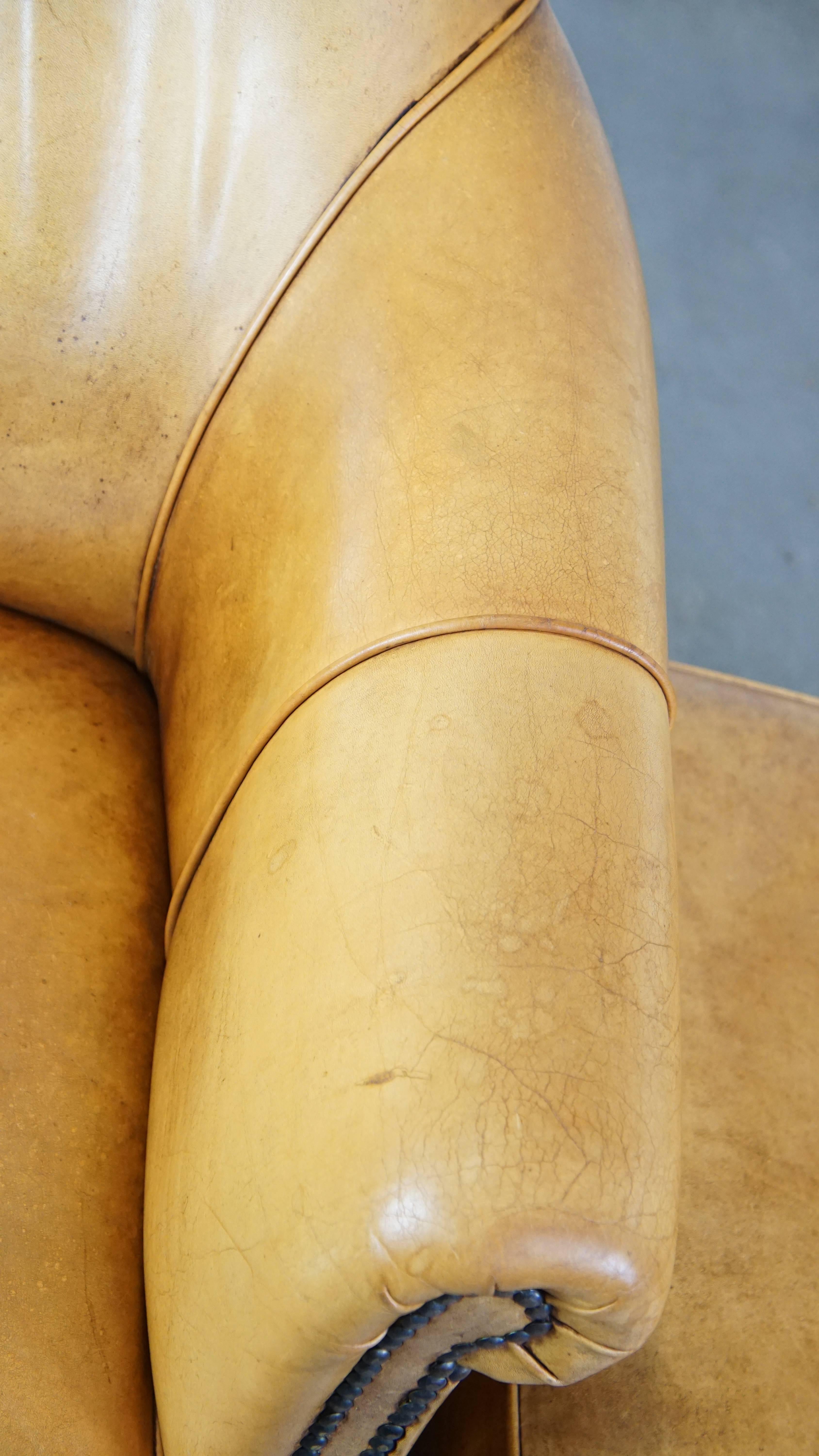 Comfortable leather armchair with ottoman, finished with decorative nails For Sale 3
